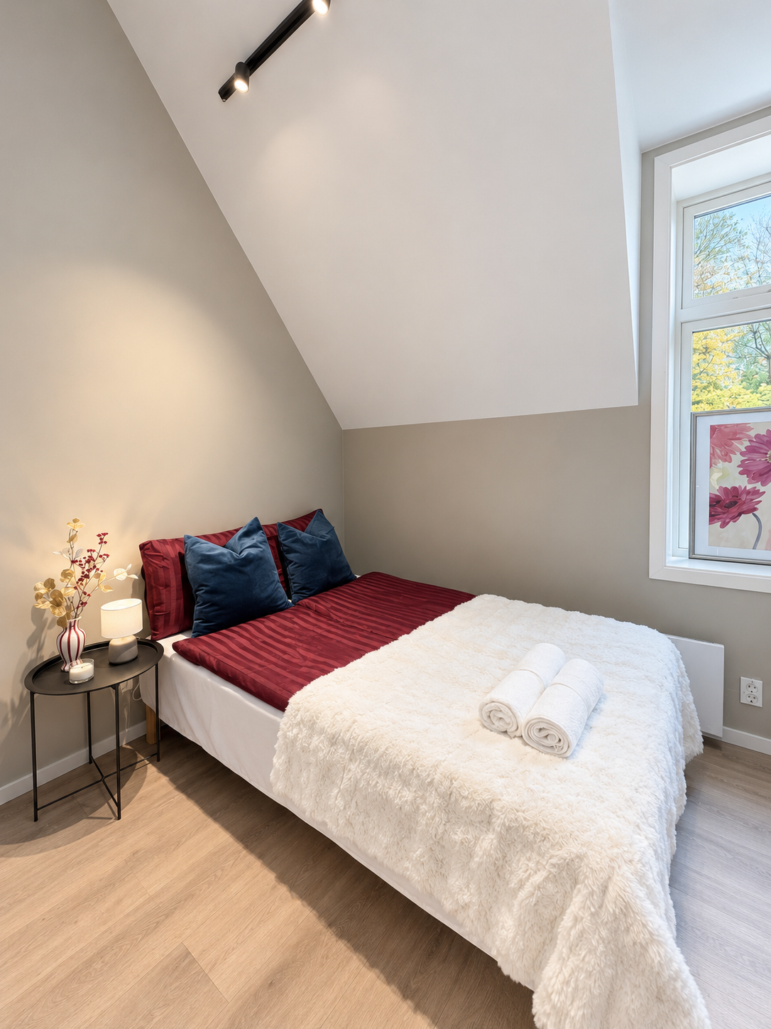 Cozy sunlit bedroom with plush bedding and modern, minimalist style