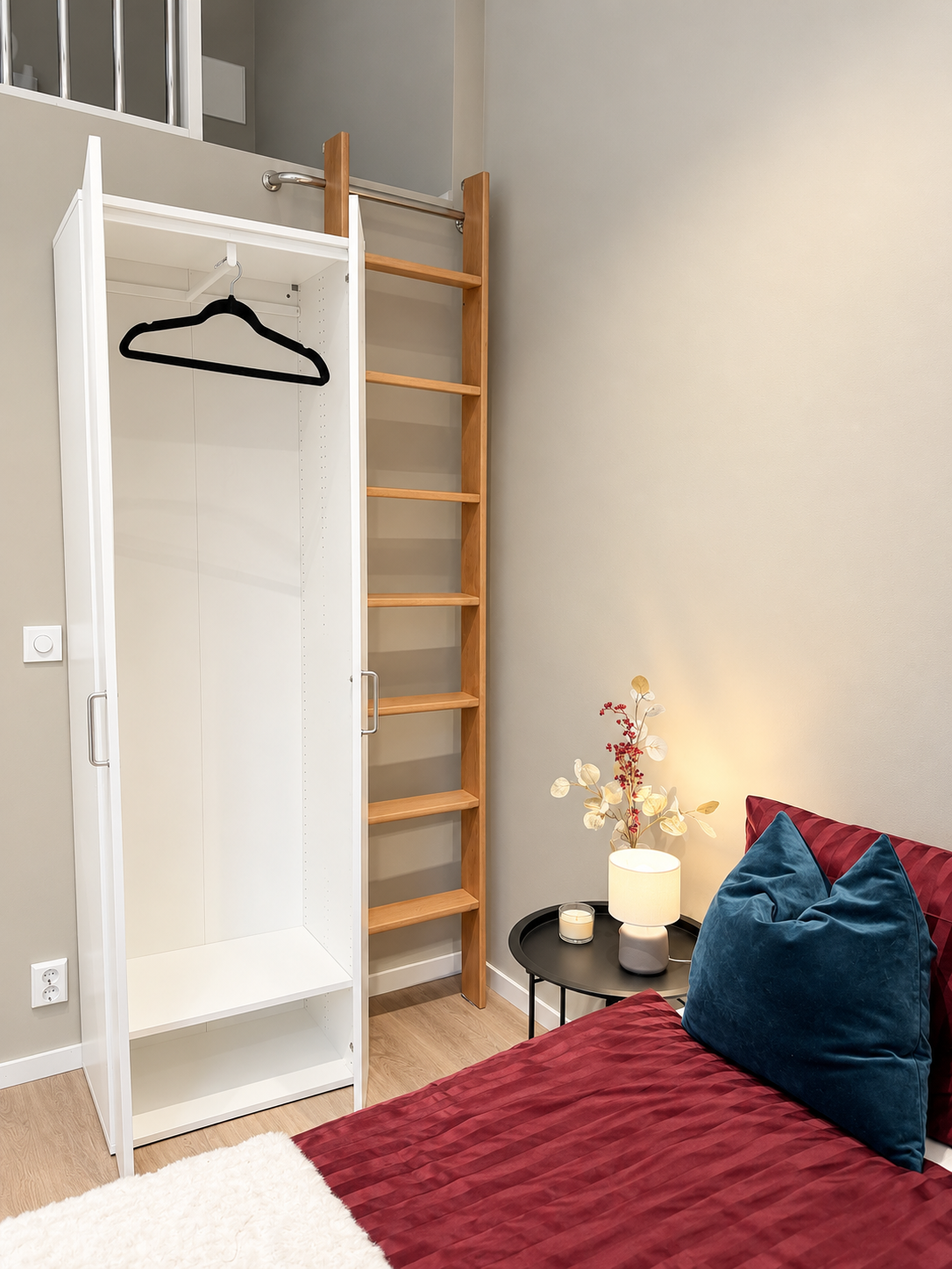 Cozy loft-style bedroom with stylish decor, wardrobe, and warm lighting