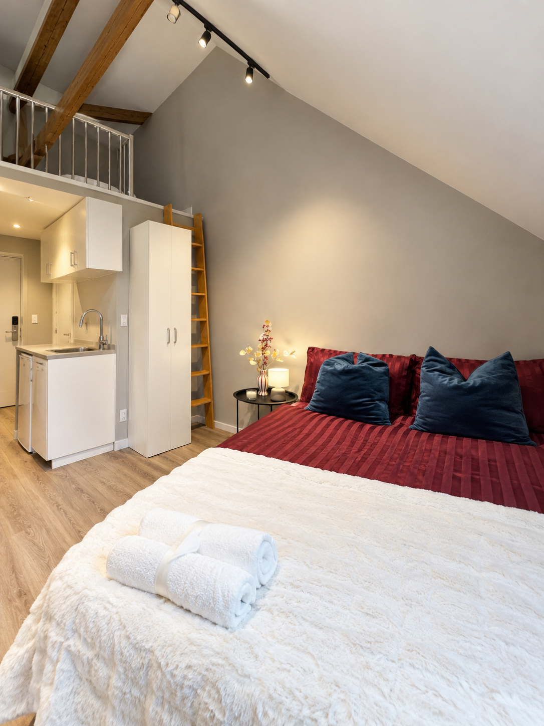 Cozy loft-style studio with vaulted ceilings and kitchenette