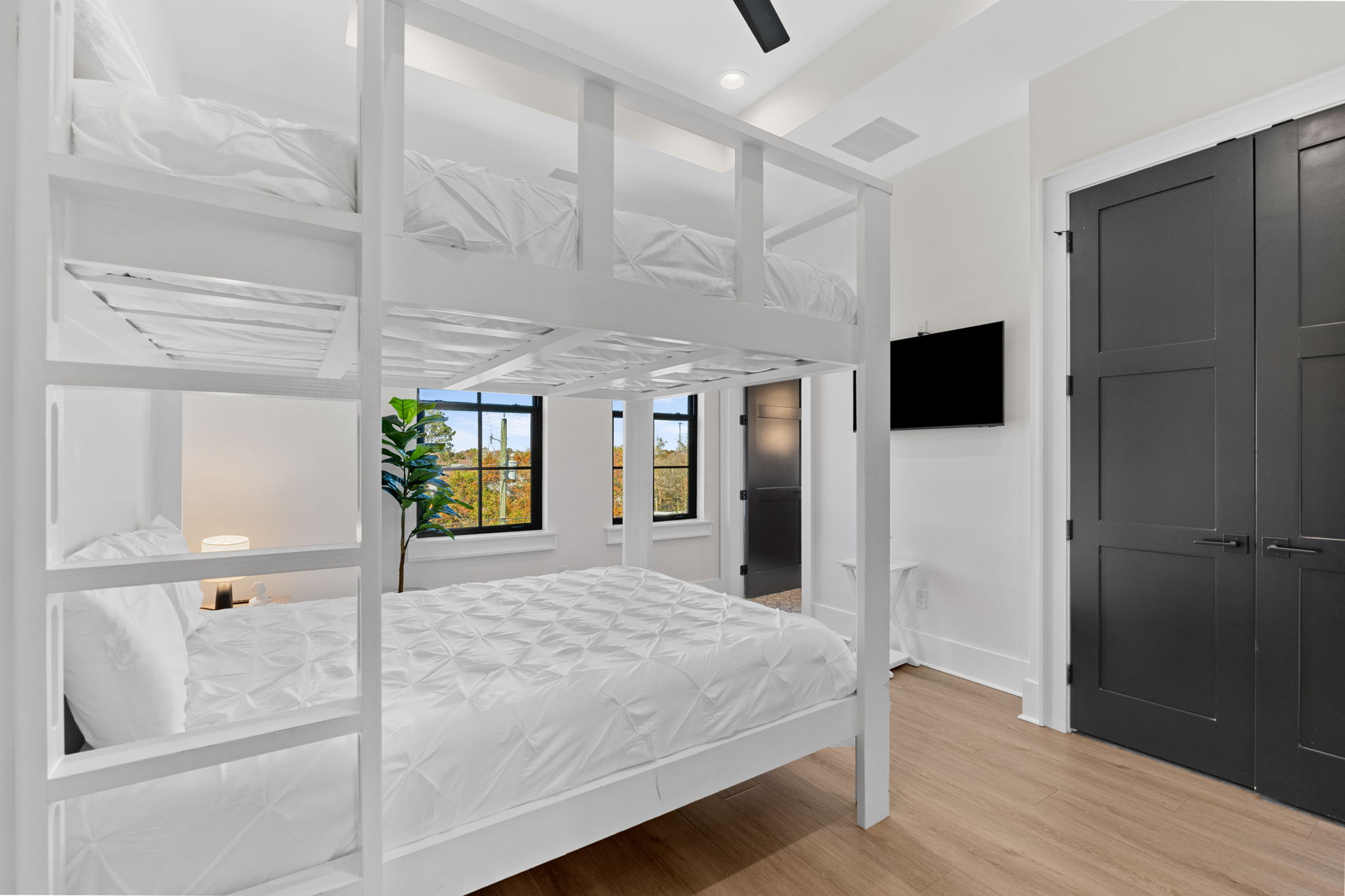 Bright modern bunk room with TV, natural light, and family-friendly sleeping space