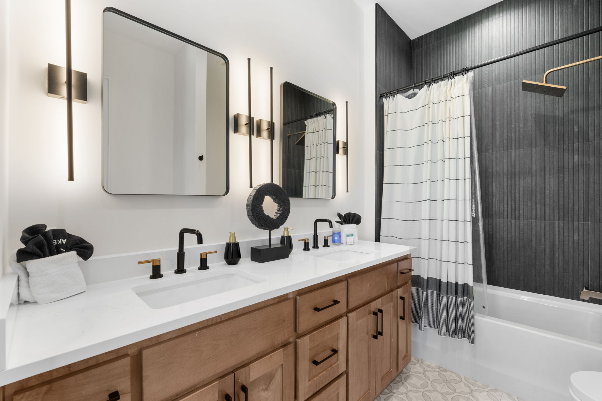 Modern double-vanity bathroom with bold accent wall and tub-shower