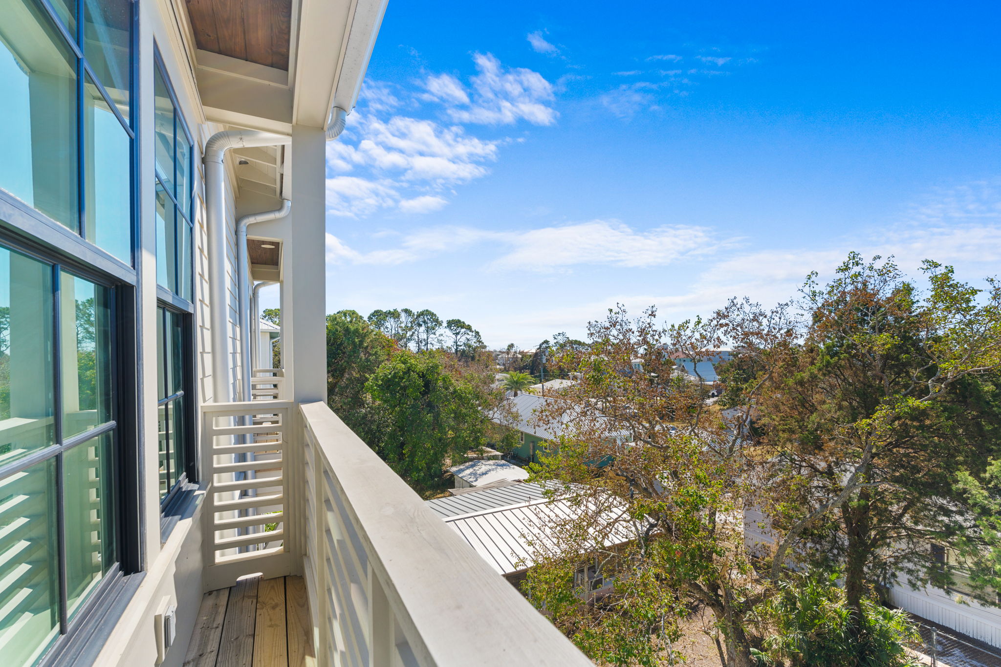 Private upper balcony with treetop views and bright, airy charm