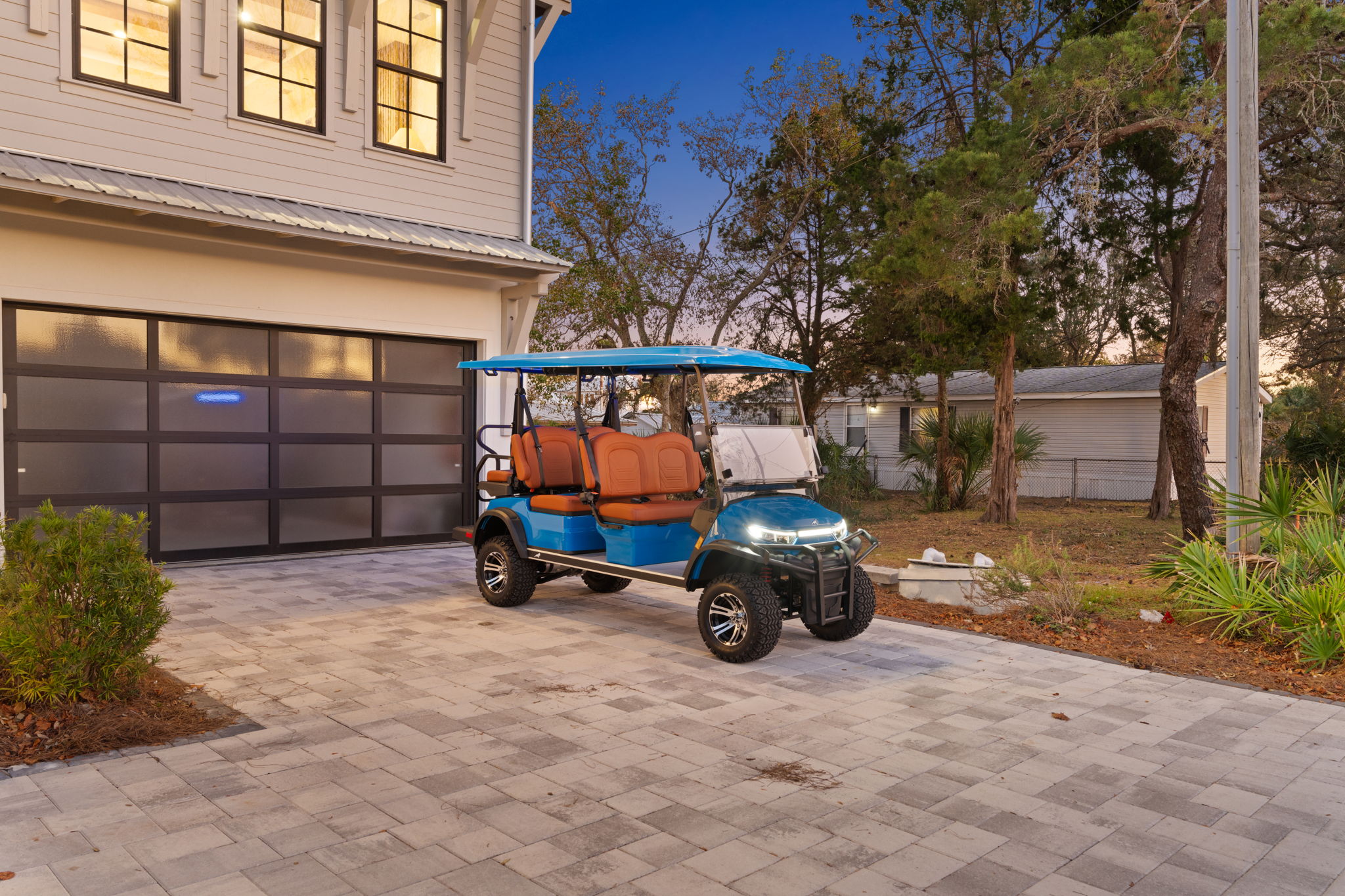 Spacious driveway with stylish golf cart and modern curb appeal