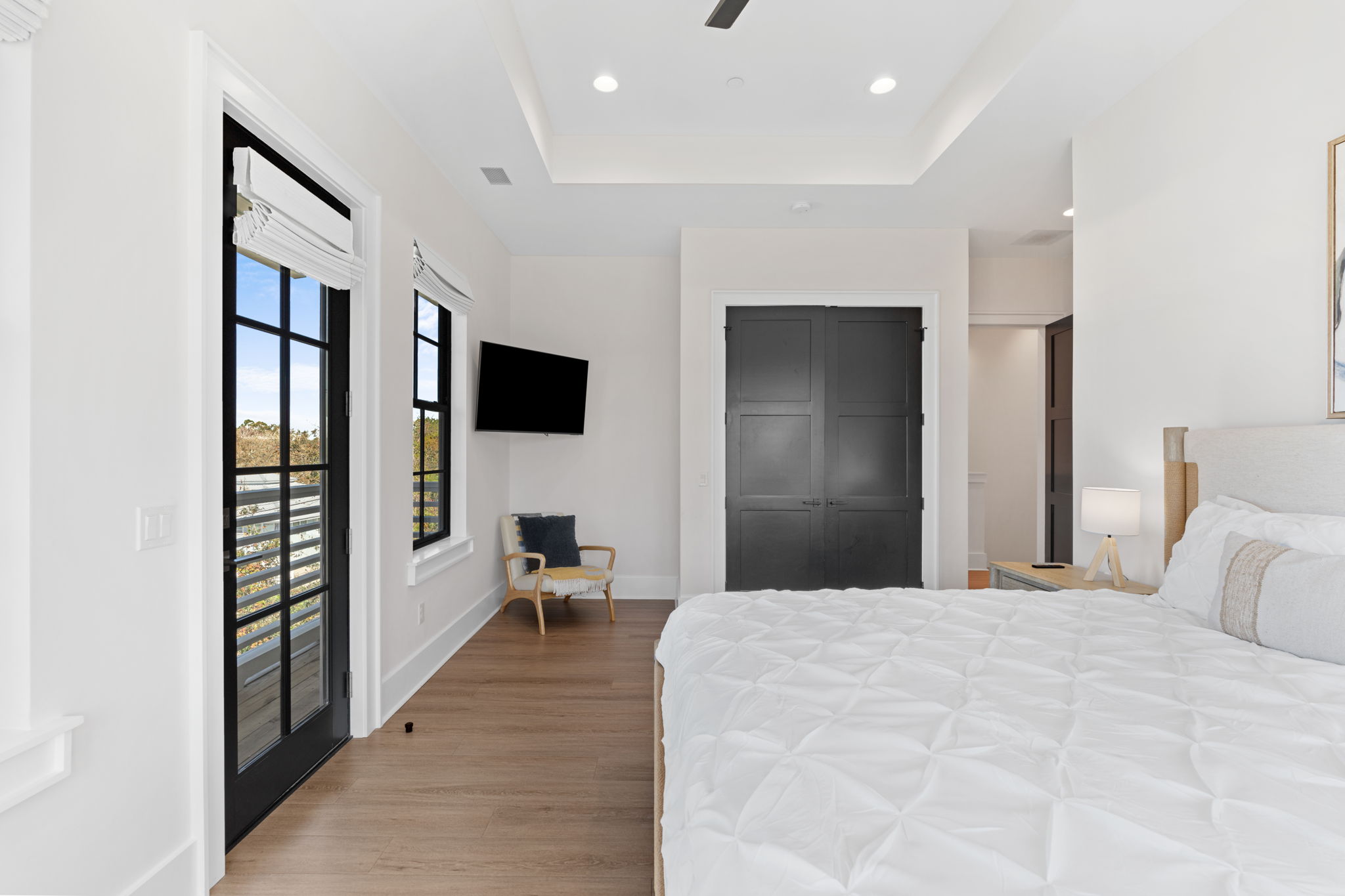 Bright modern bedroom with balcony access and sleek designer touches