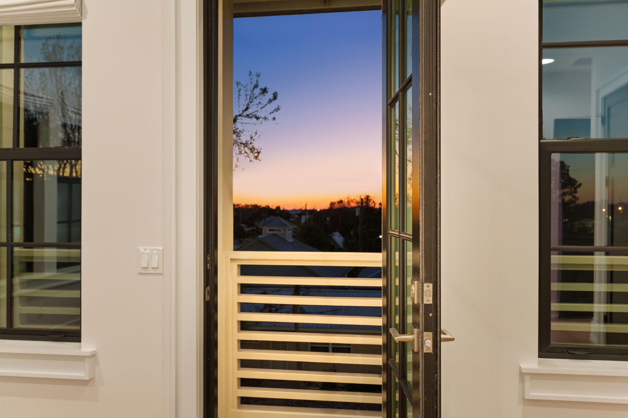 Open balcony door with stunning sunset views and modern design