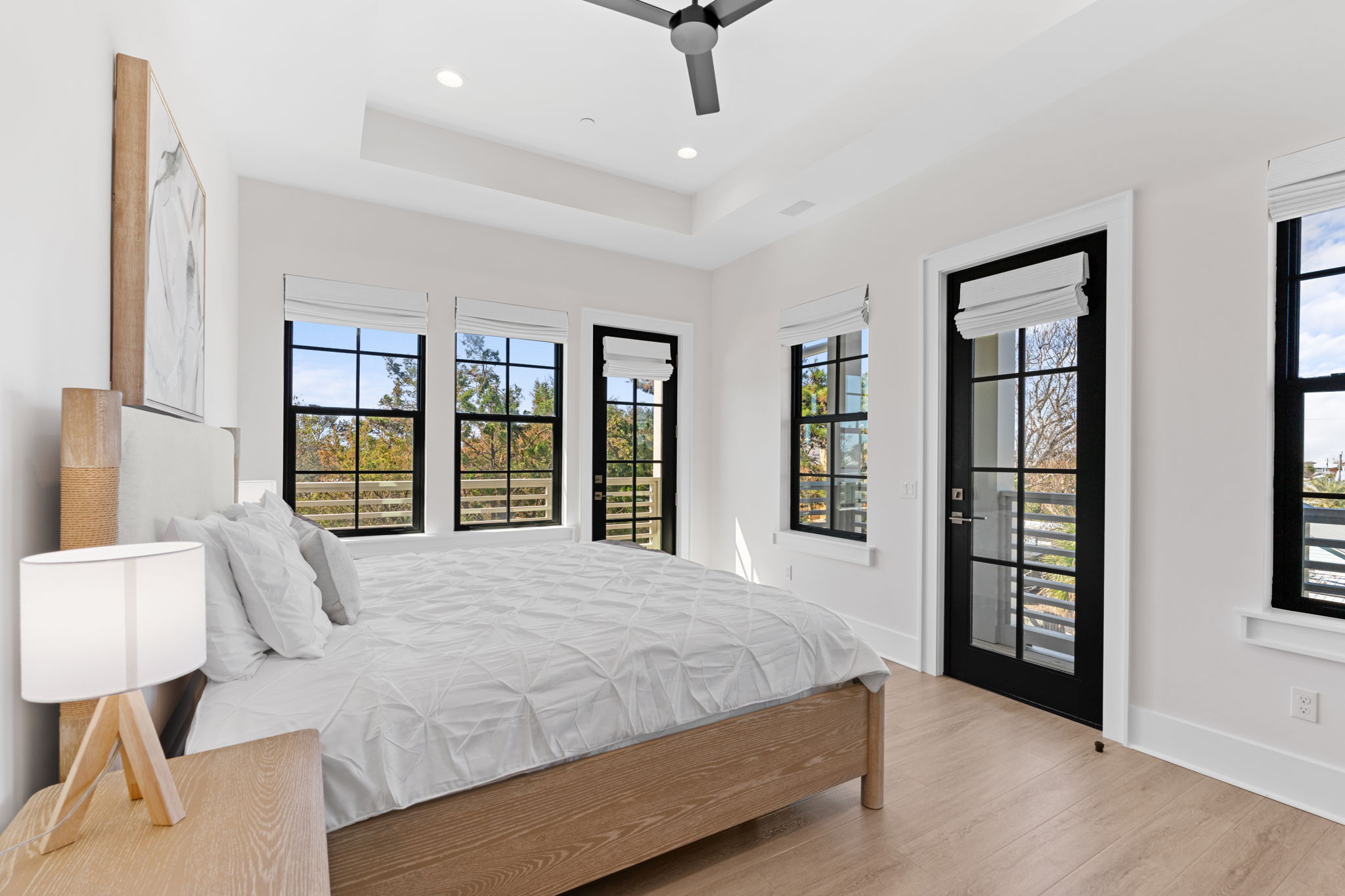 Bright modern bedroom with balcony access and abundant natural light