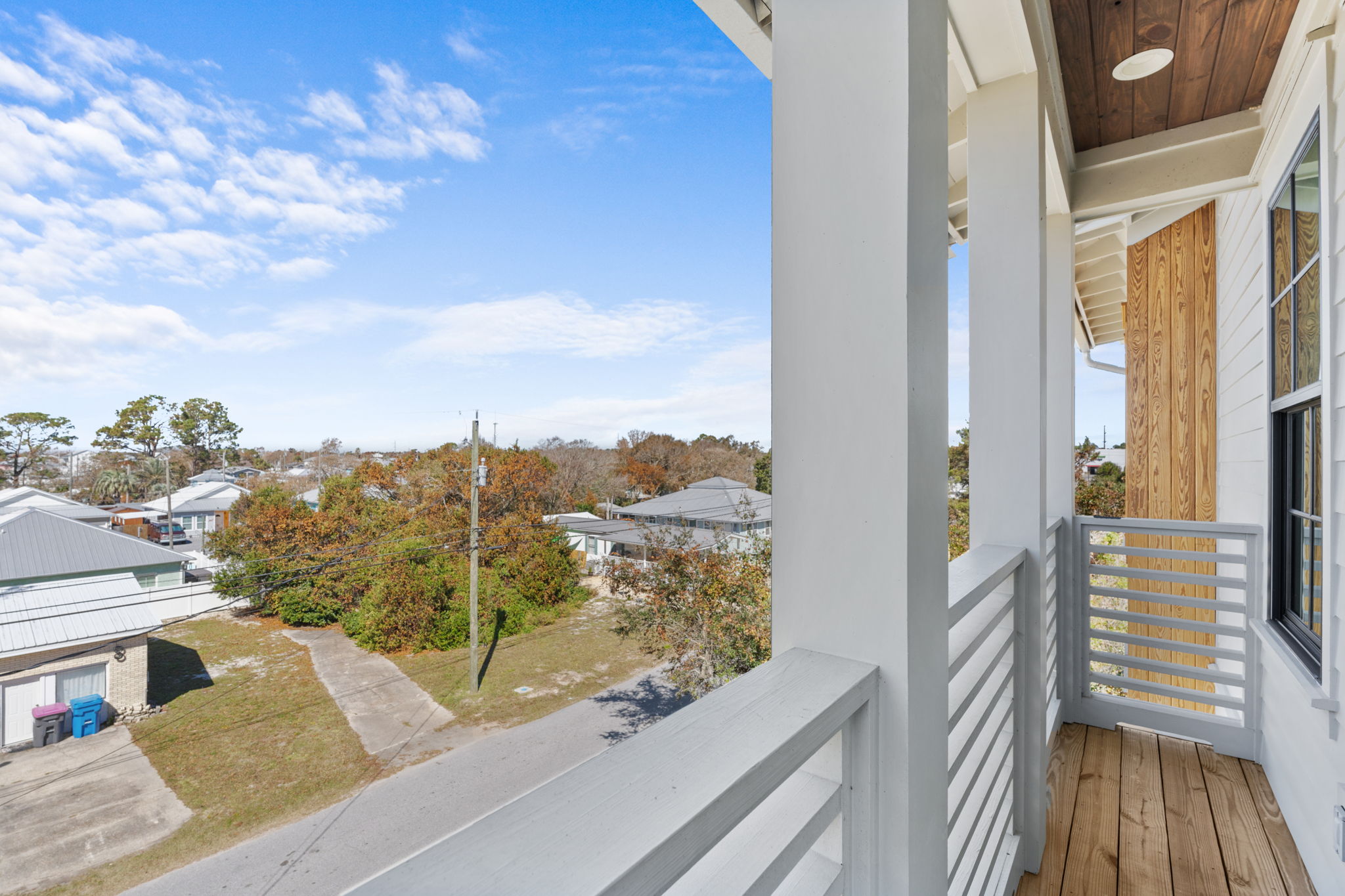 Sunny private balcony with peaceful neighborhood views