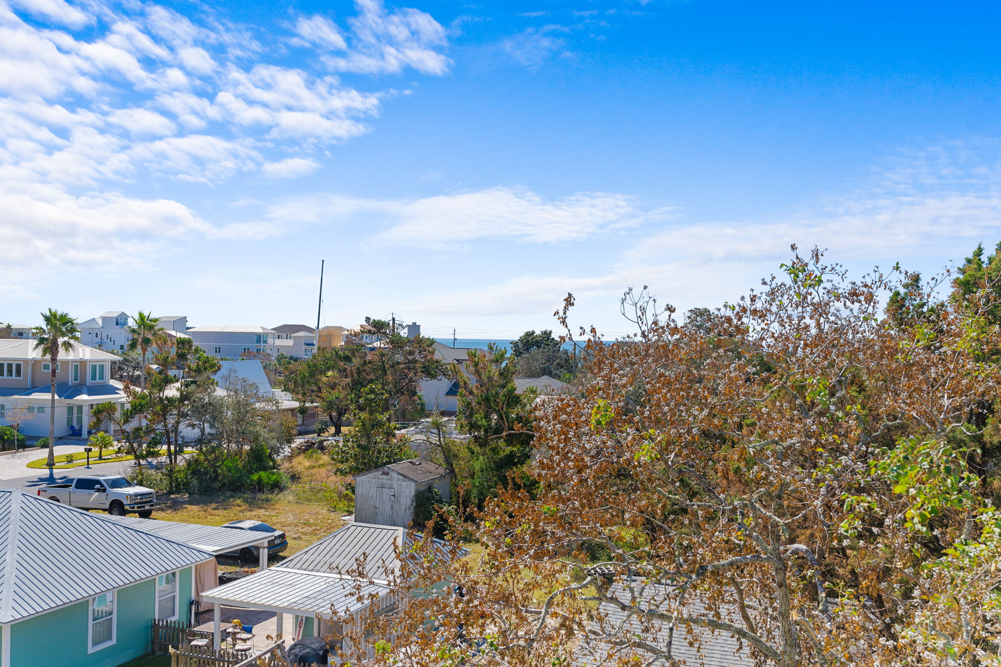 Bright coastal neighborhood views with a glimpse of the water