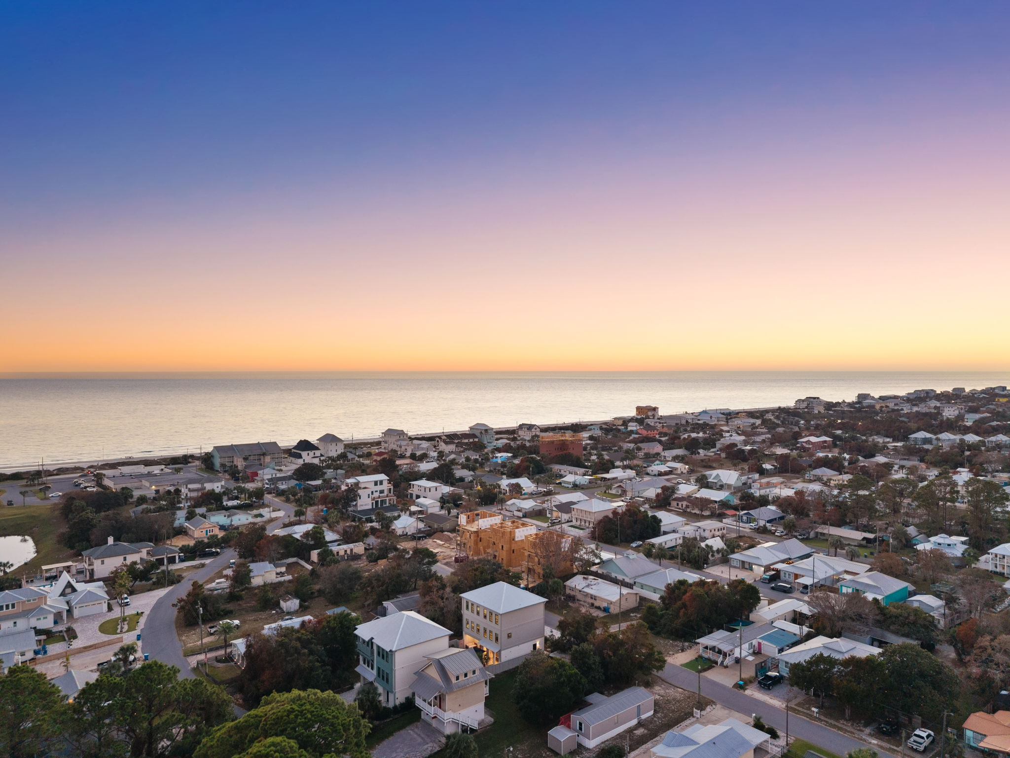 Sweeping coastal neighborhood and ocean views at sunset