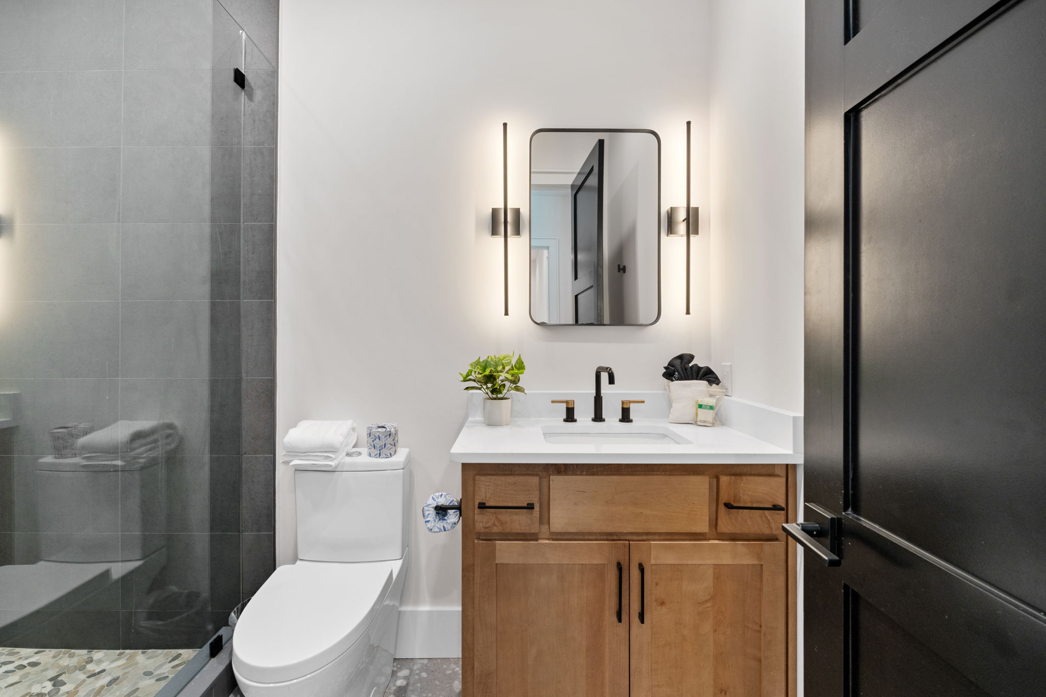 Modern spa-inspired bathroom with glass shower and stylish vanity