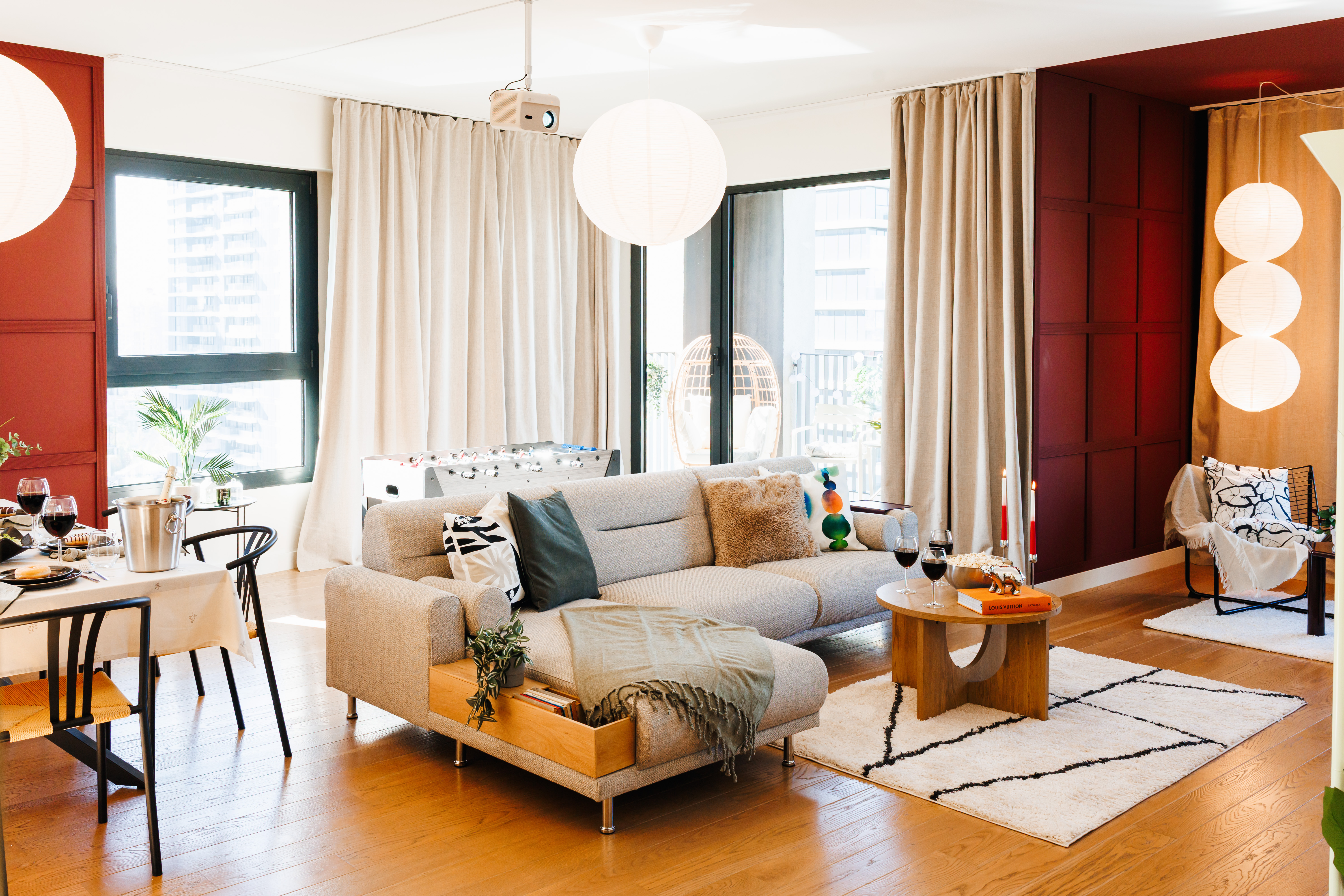 Bright designer lounge with balcony access, cozy seating, and fun foosball