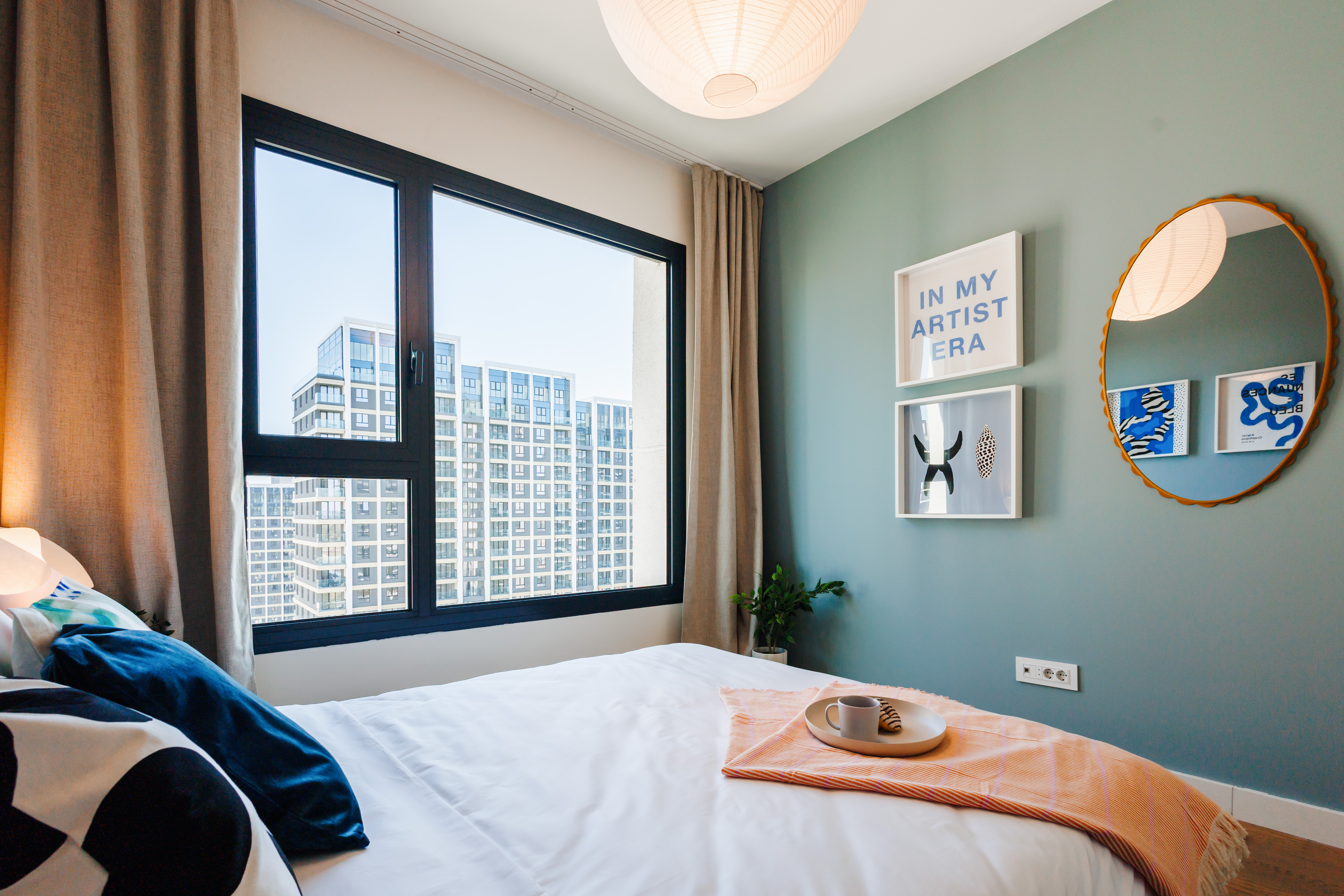 Bright modern bedroom with skyline views and stylish decor