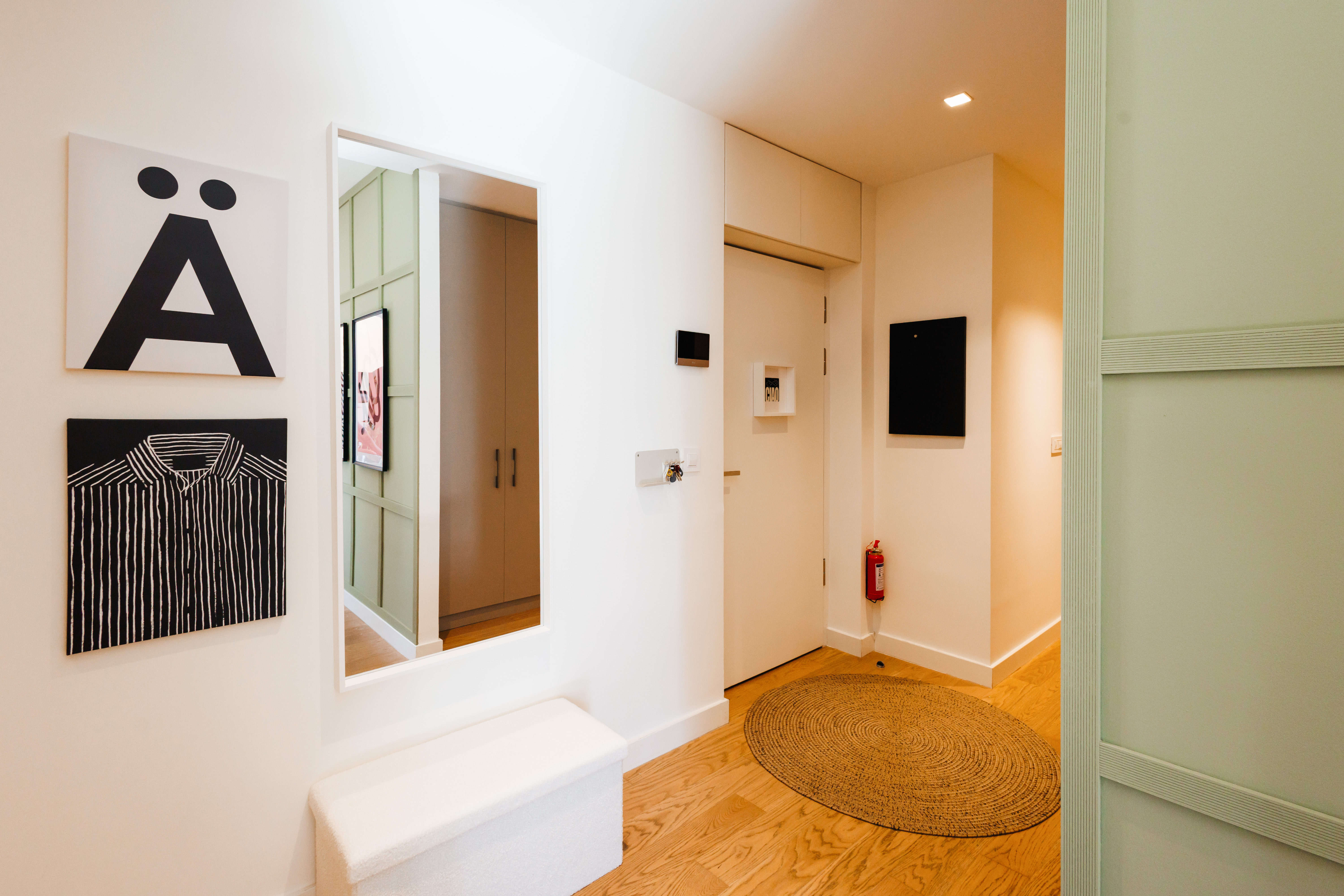 Bright, stylish entryway with mirror, bench, and warm modern design