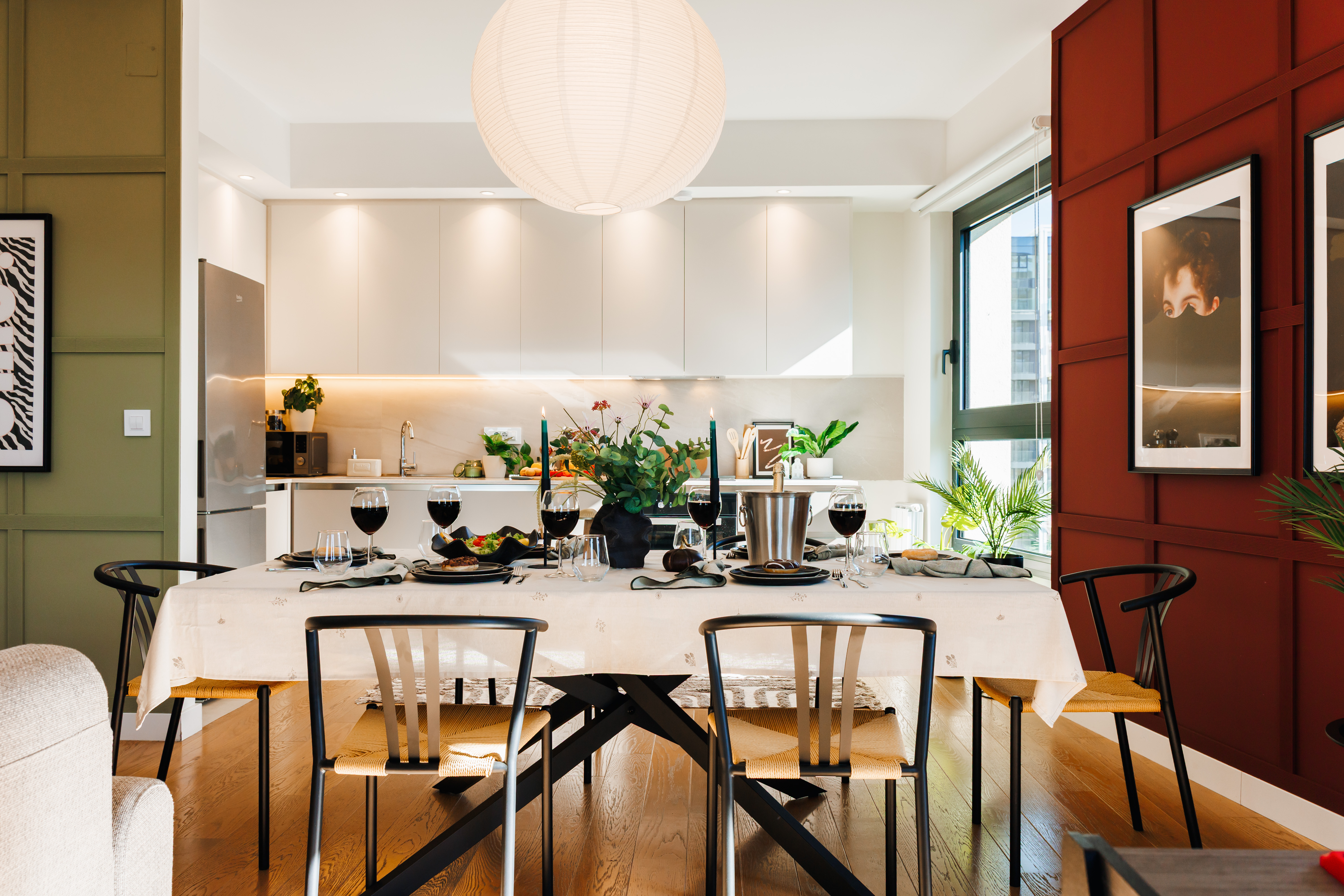 Stylish dining for six beside a sleek, light-filled modern kitchen