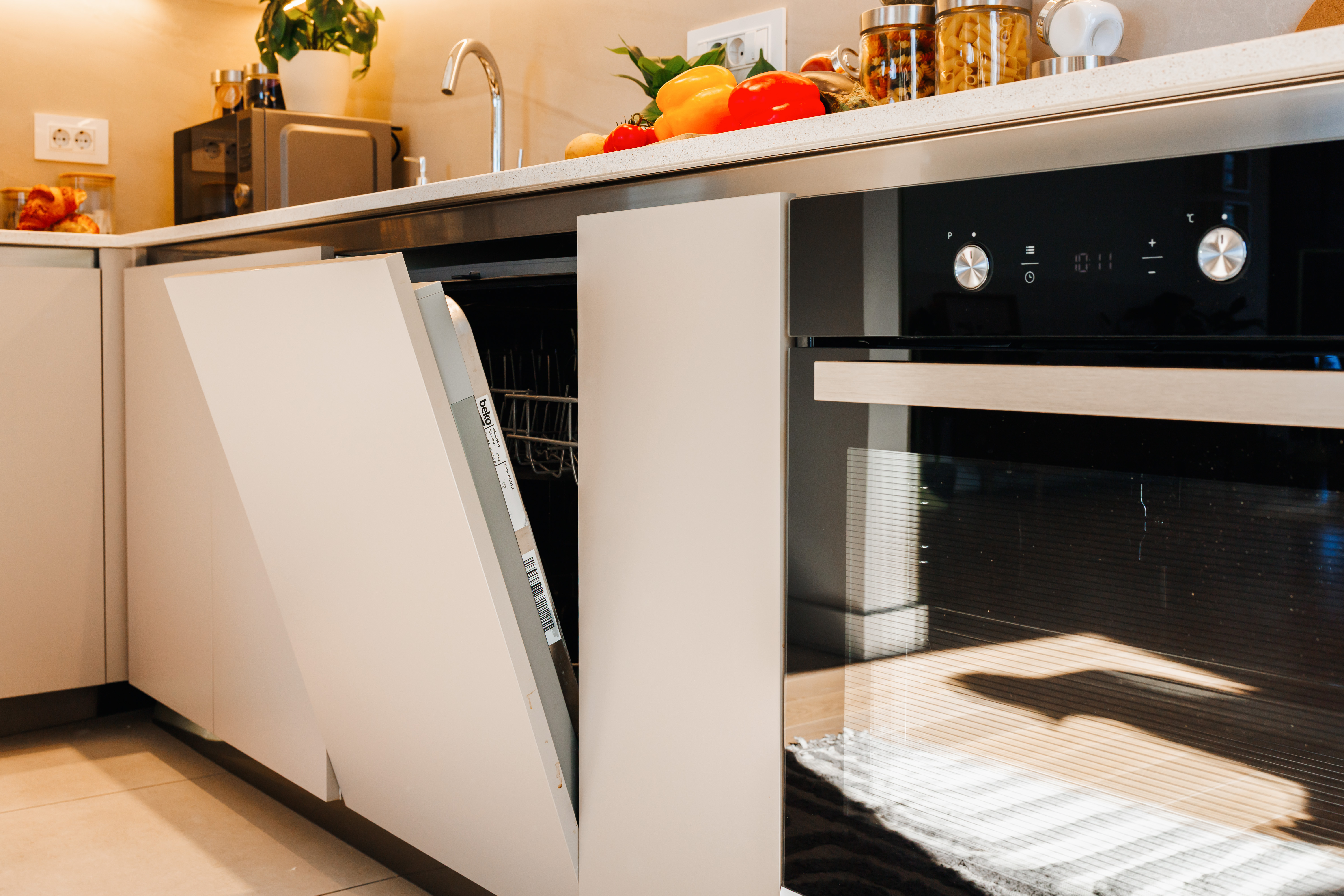 Modern kitchen with built-in oven, dishwasher, and bright counter space