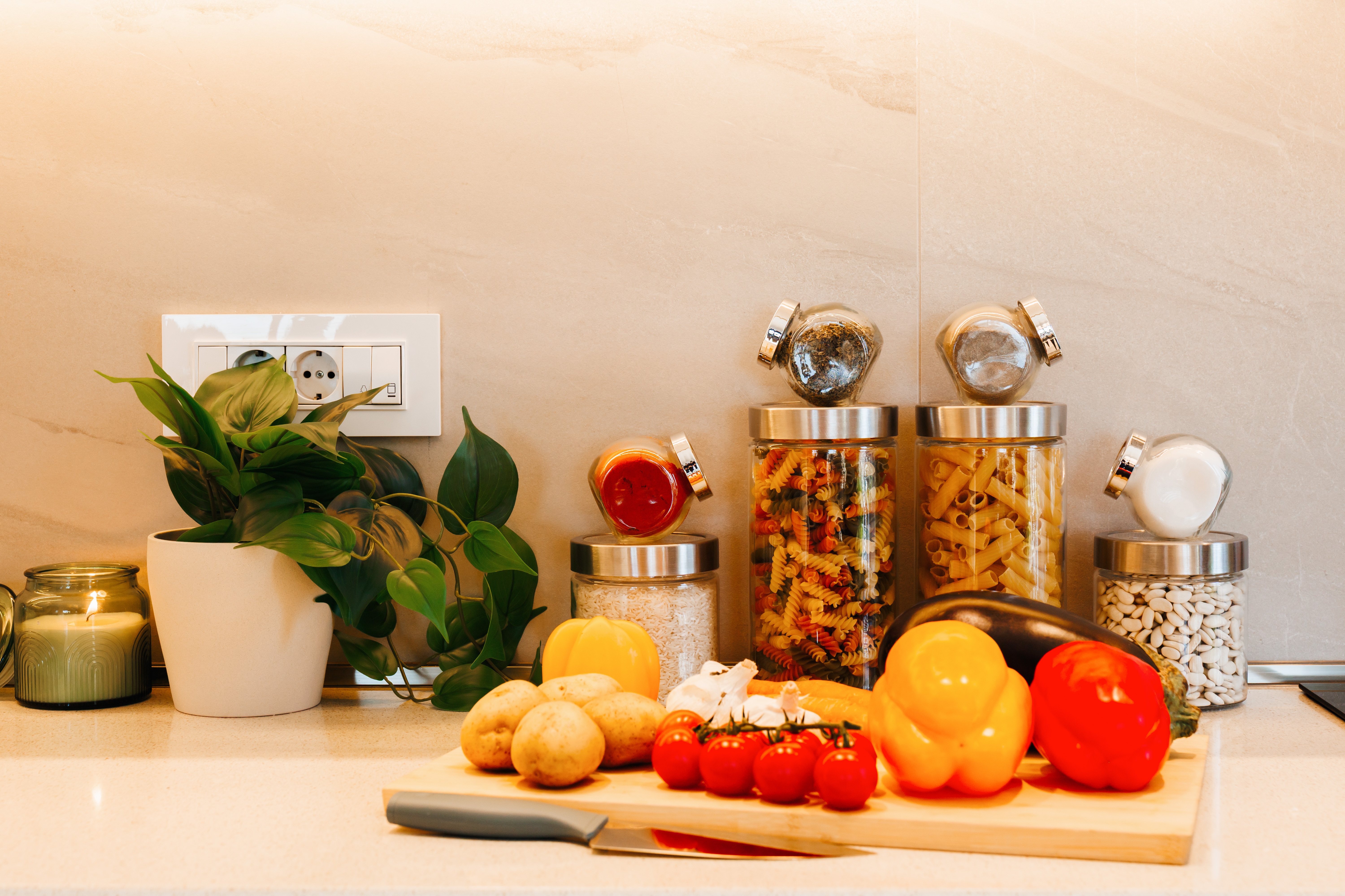 Bright modern kitchen with stocked pantry jars and fresh prep space