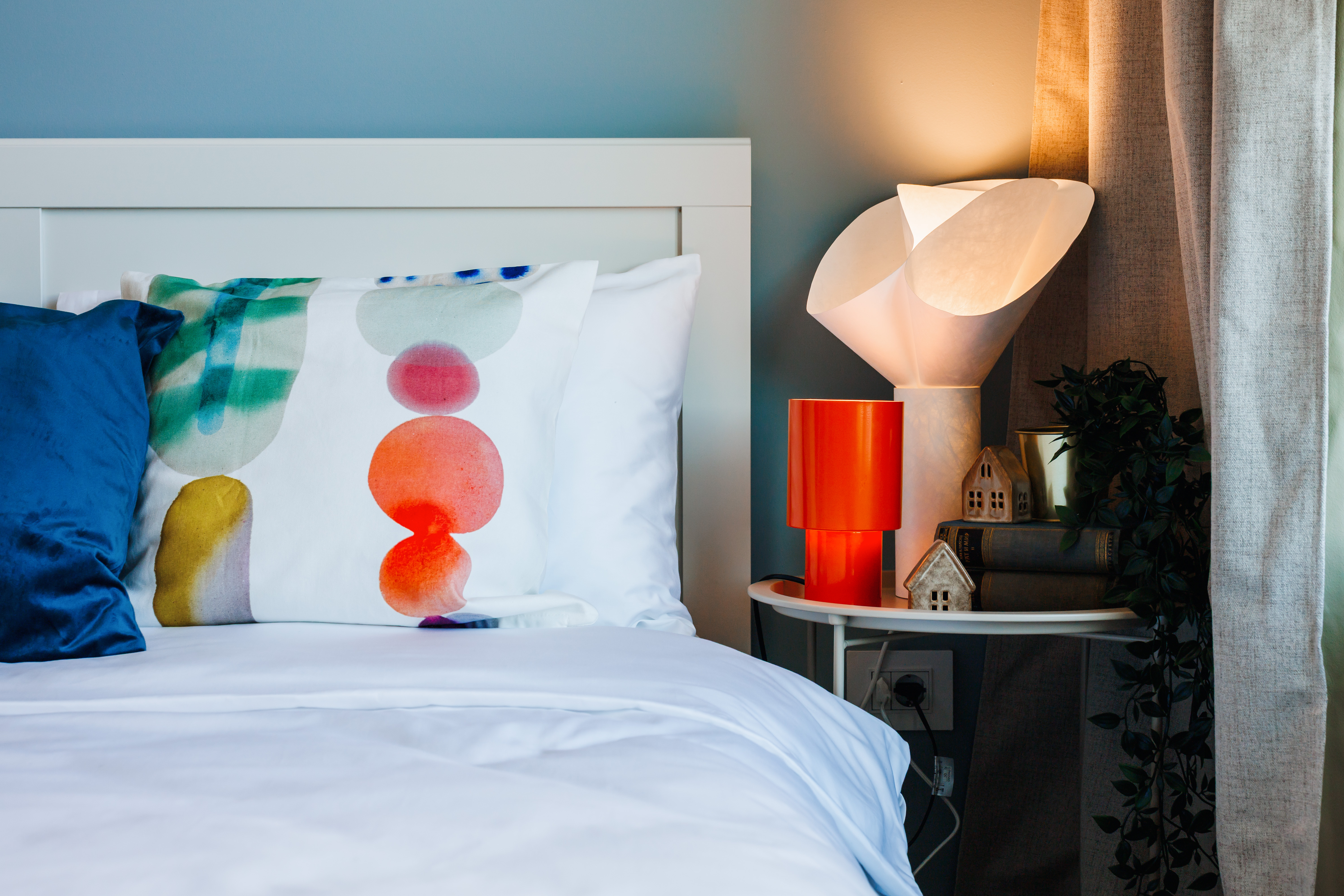 Cozy modern bedroom with warm lighting and stylish designer touches