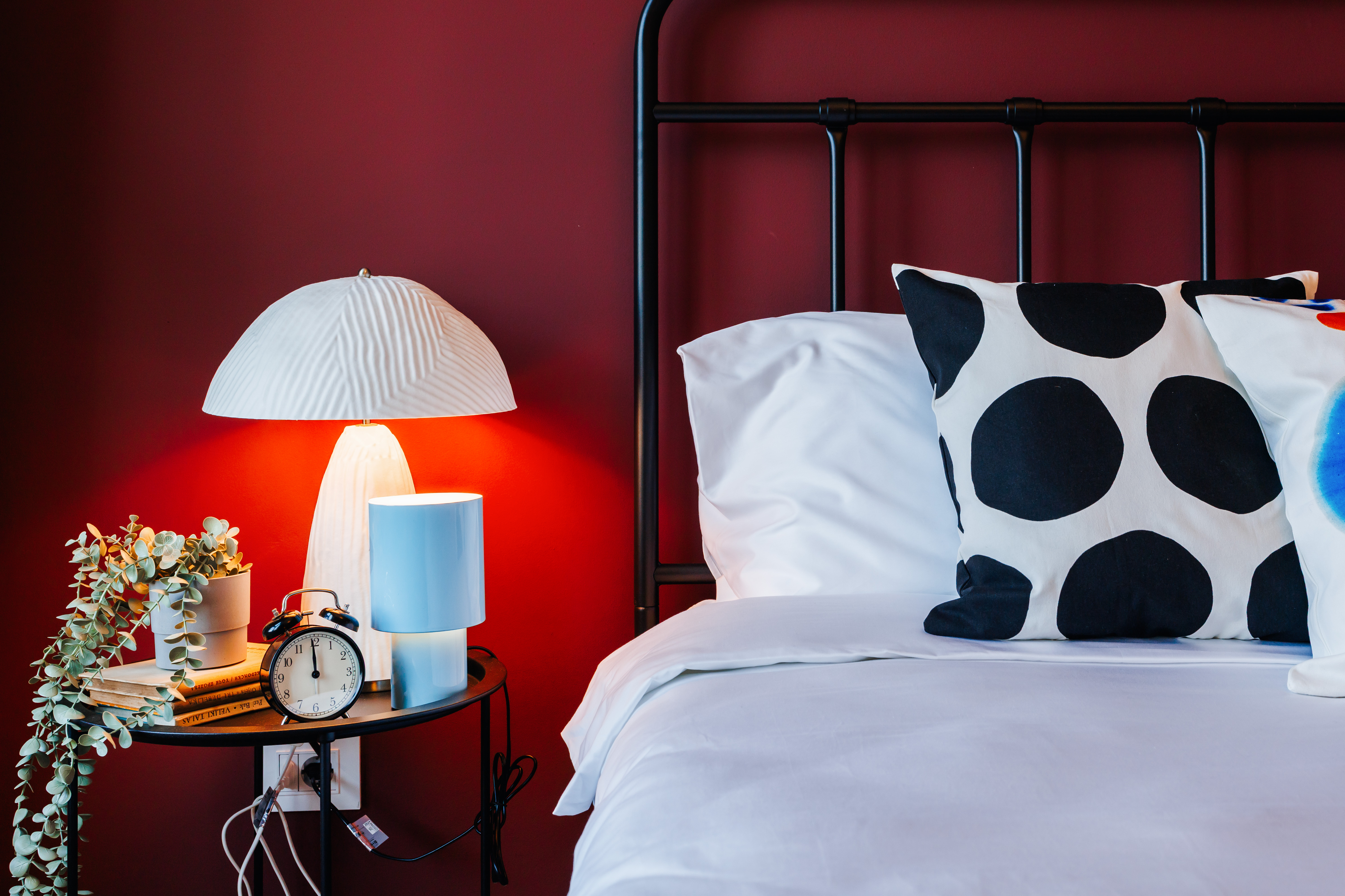 Bold accent wall and chic bedside styling for a boutique bedroom feel