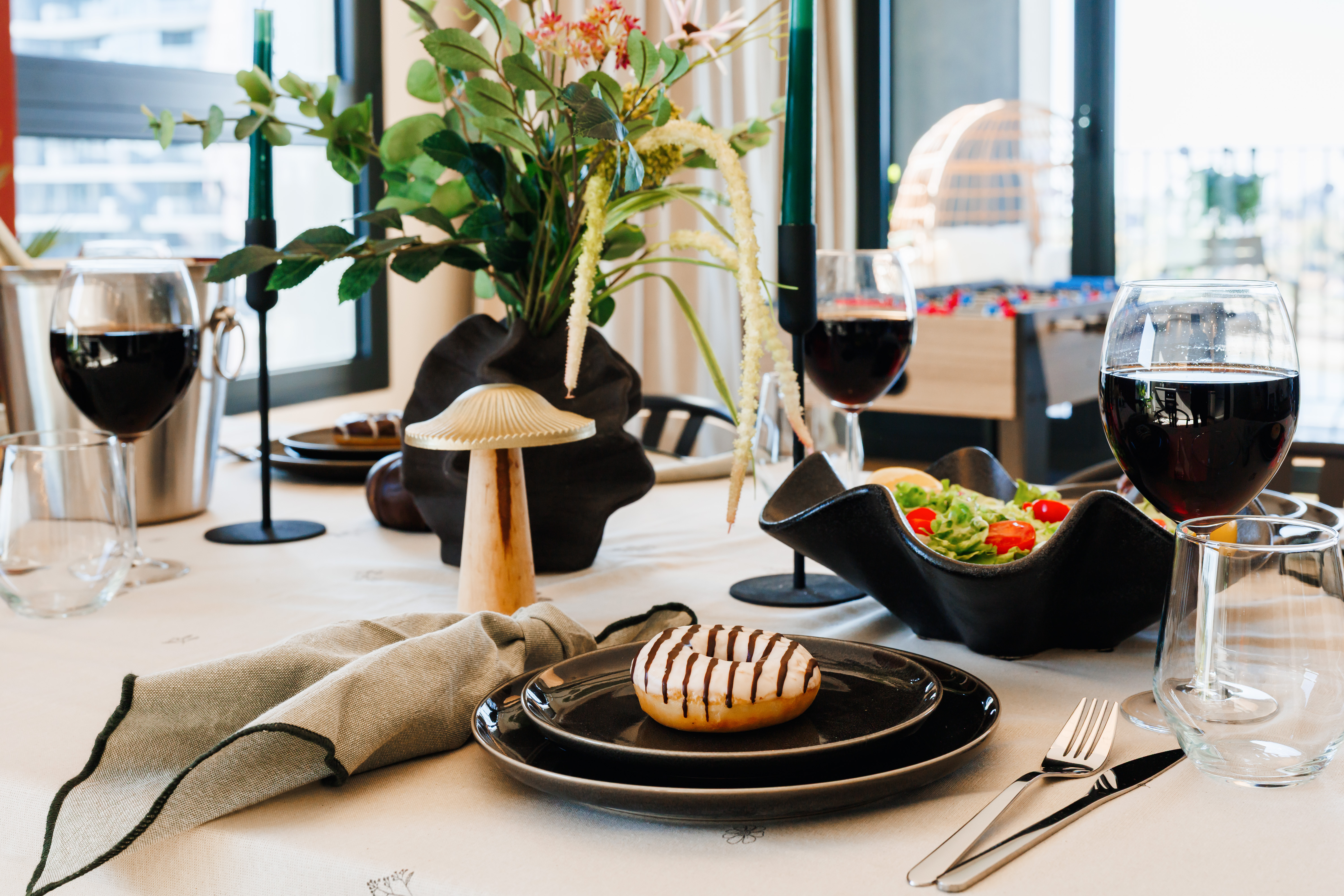 Elegant dining setup with wine, modern tableware, and chic decor