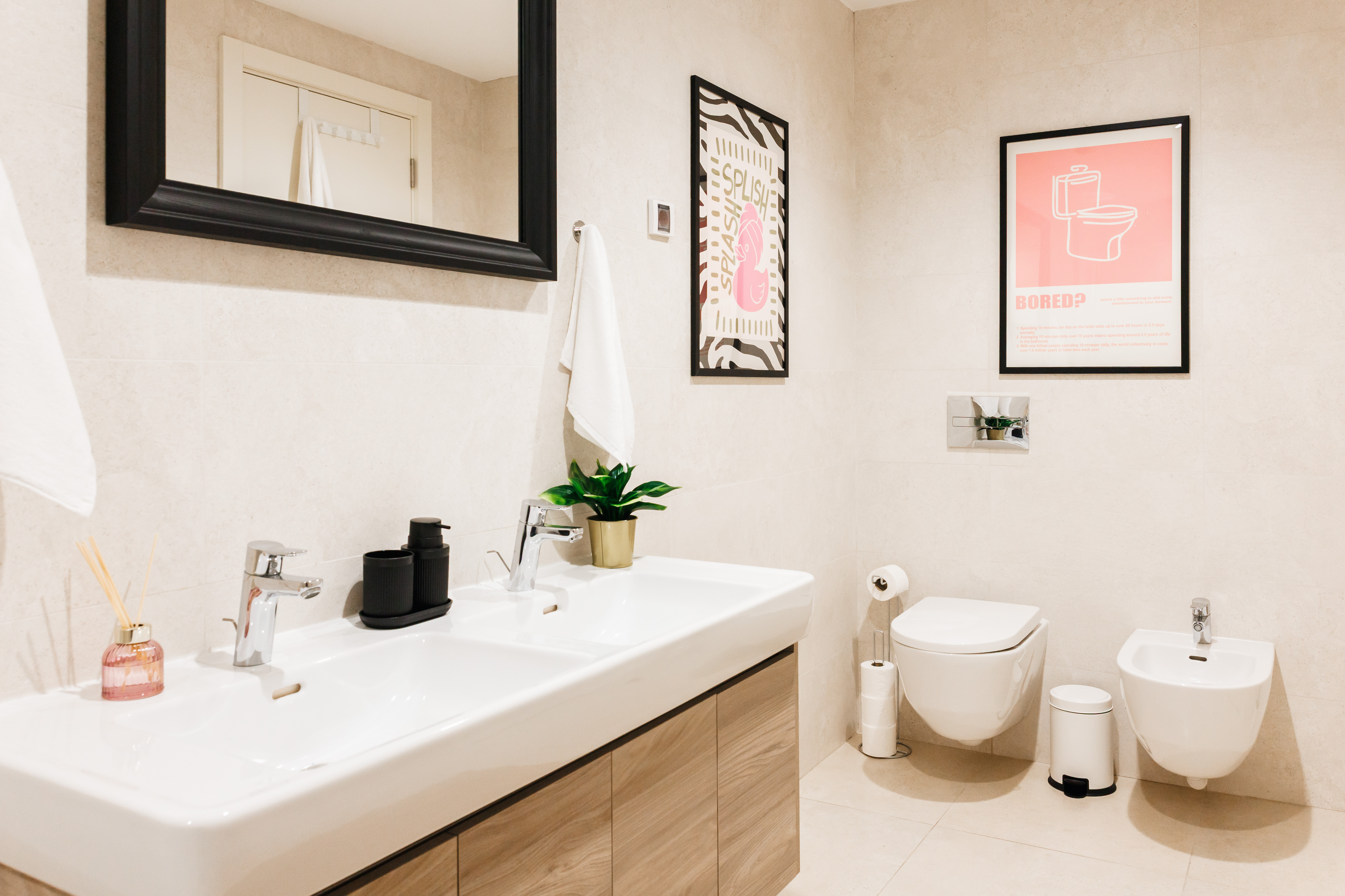 Stylish modern bathroom with double vanity, bidet, and designer touches