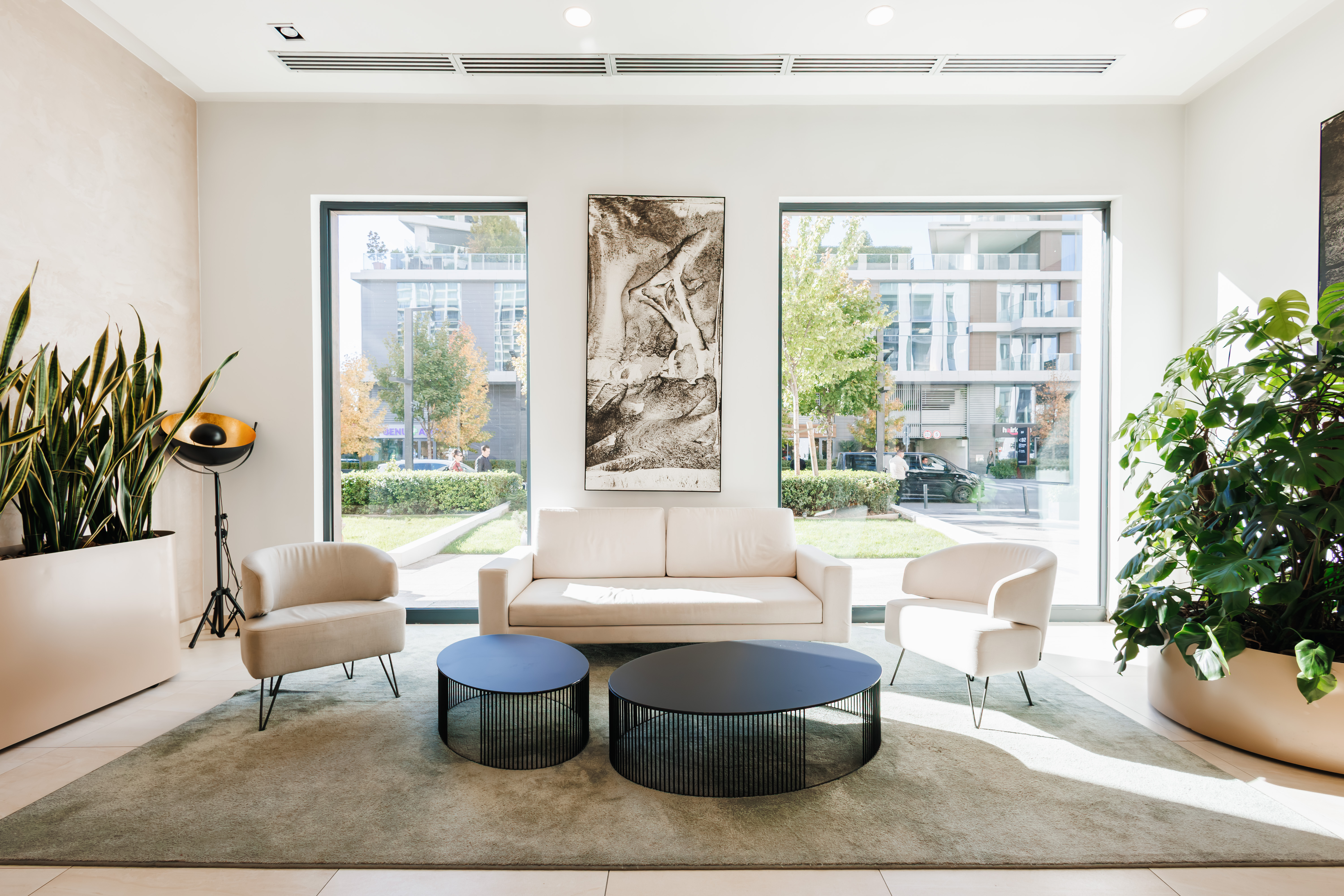 Bright modern lounge with floor-to-ceiling windows and stylish seating