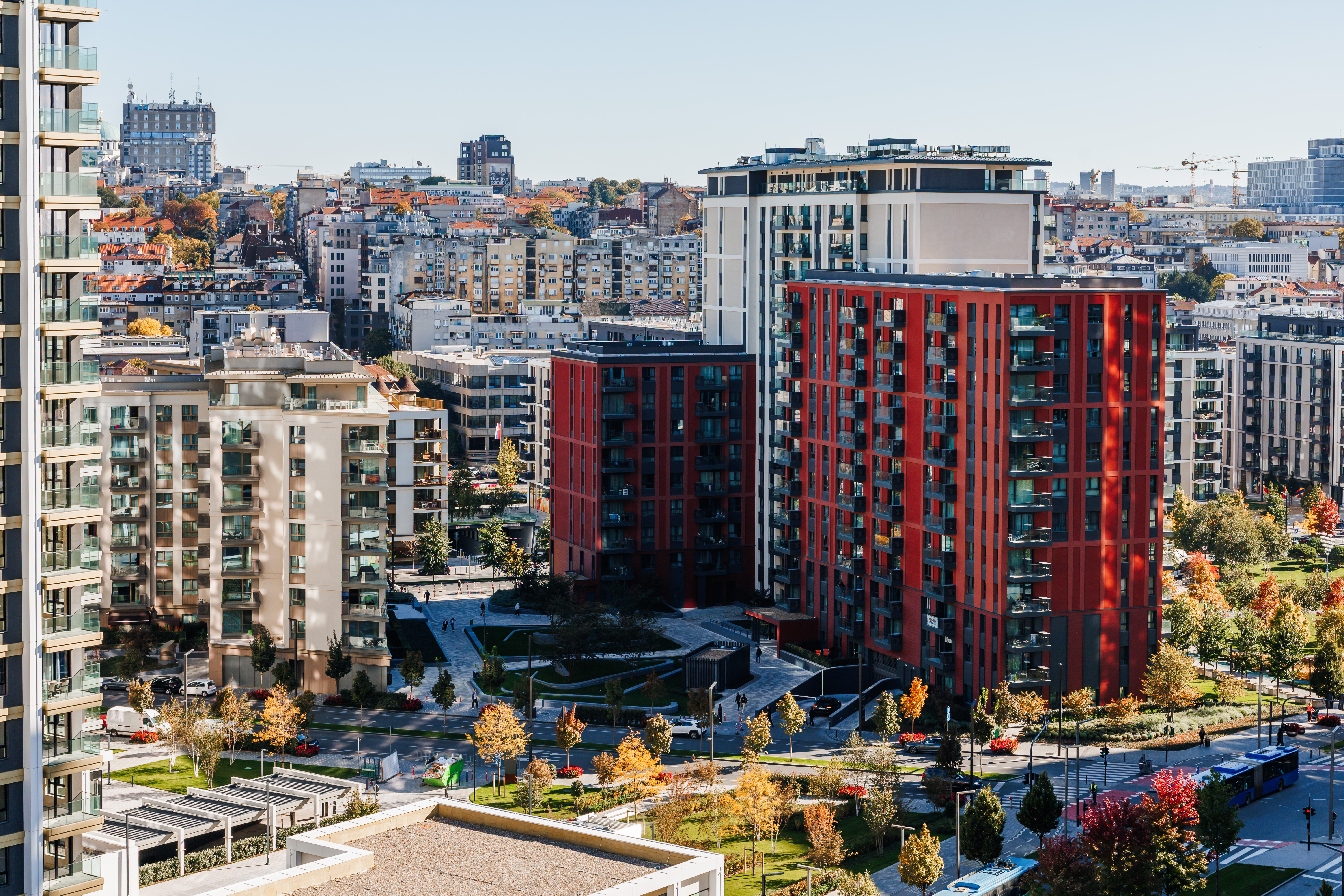 Bright city views over modern apartments and landscaped streets