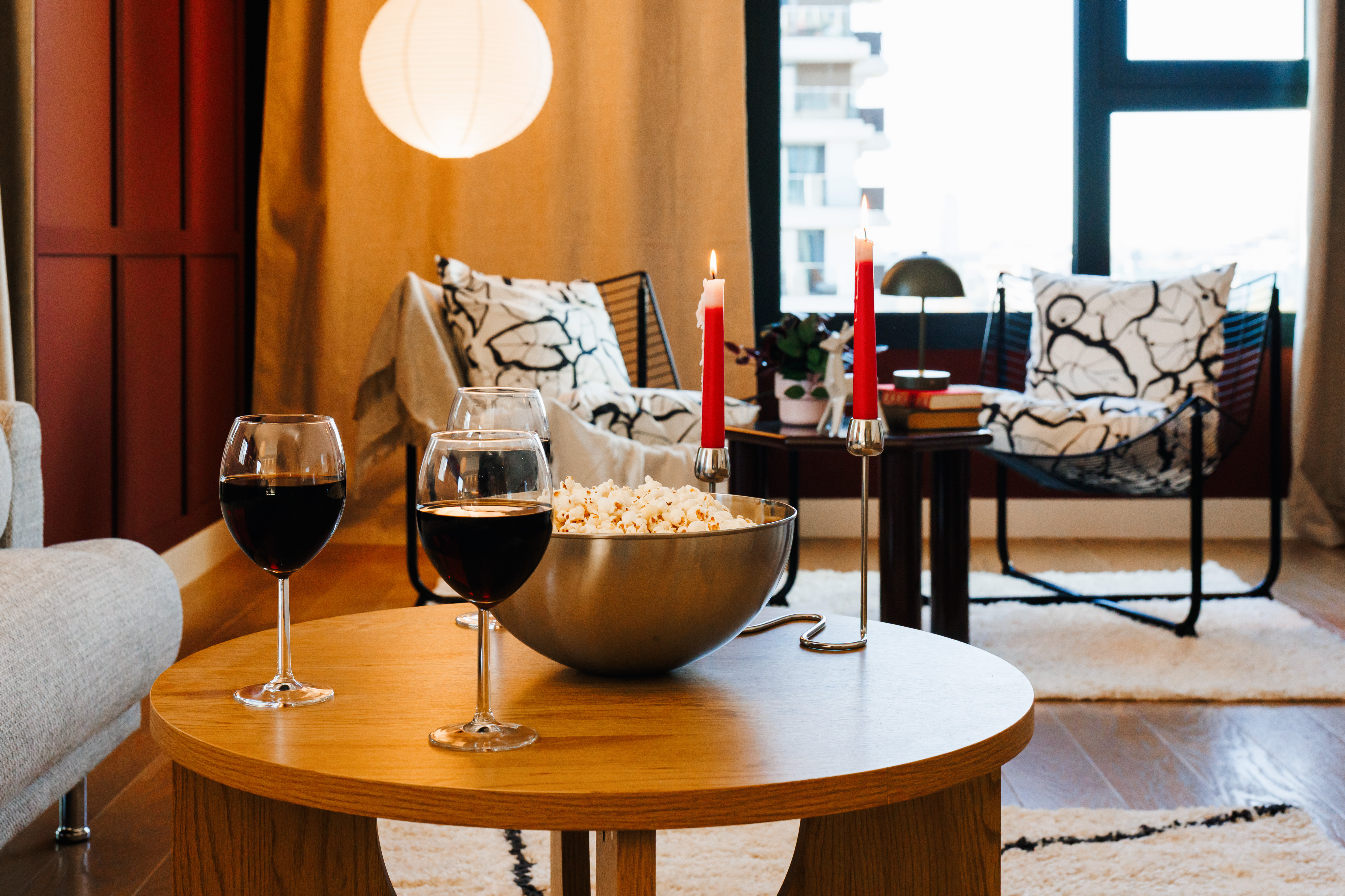 Cozy living room setup with wine, candles, and a warm modern feel