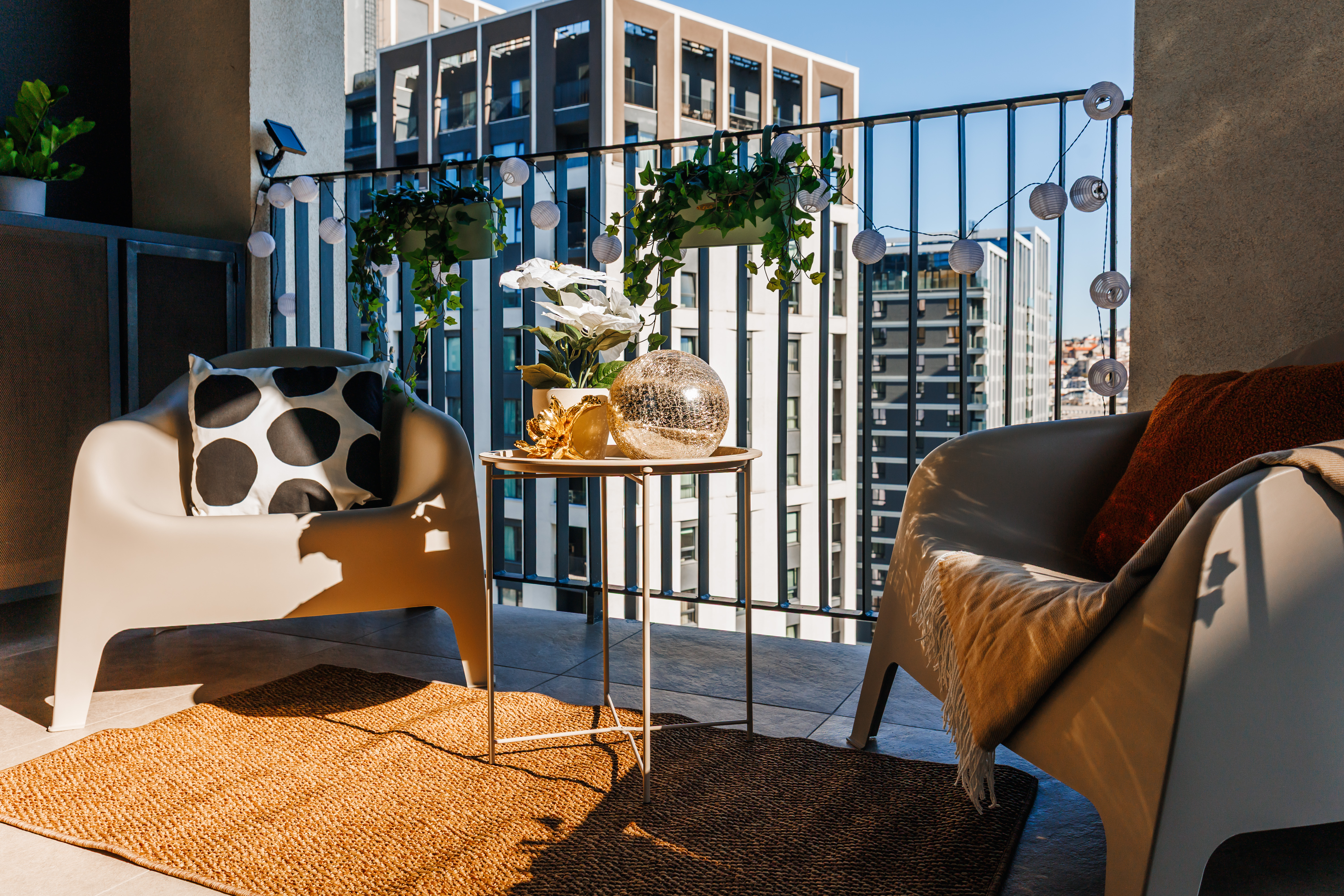 Cozy city-view balcony with stylish seating and inviting ambiance