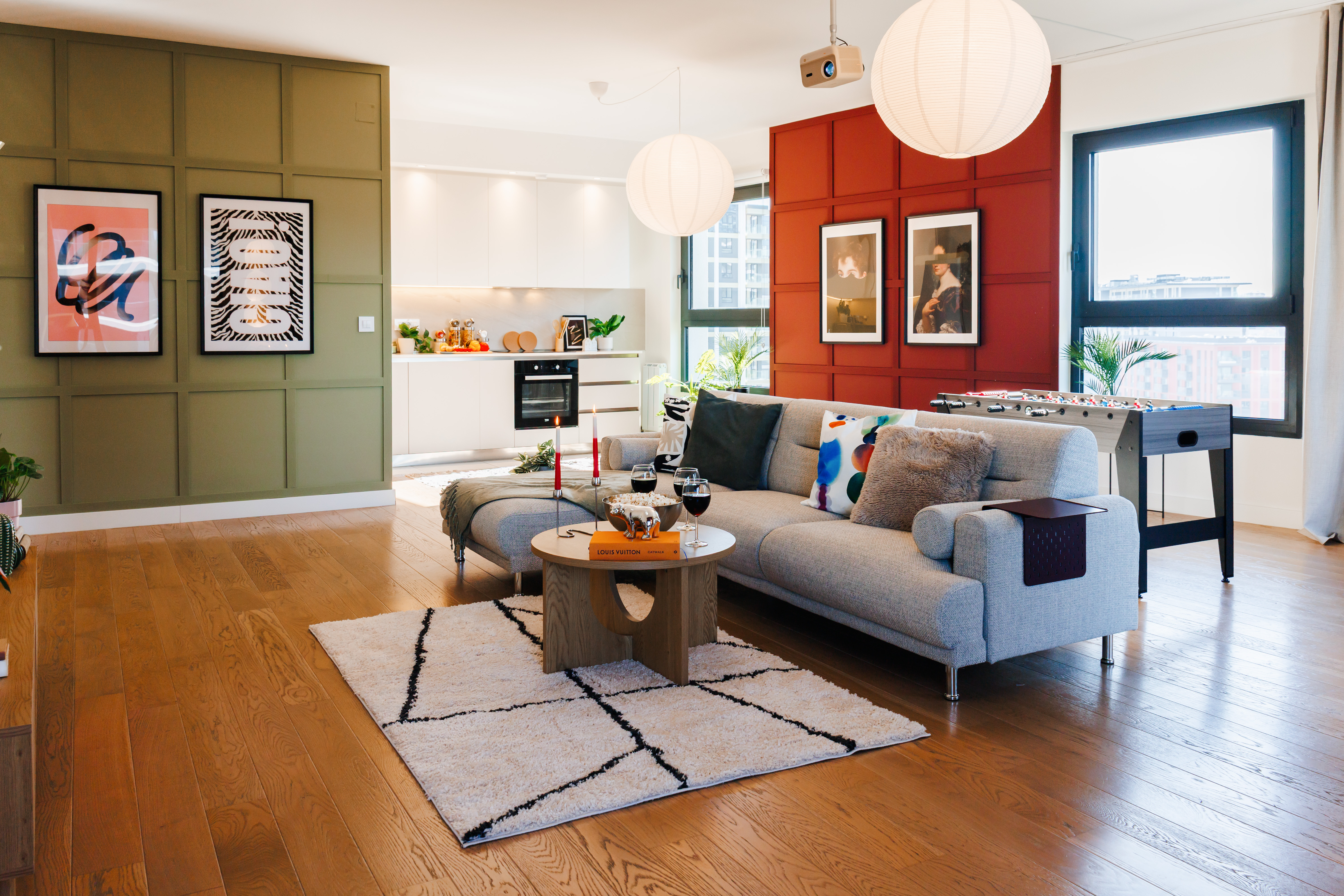 Bright designer lounge with open kitchen, city views & foosball fun