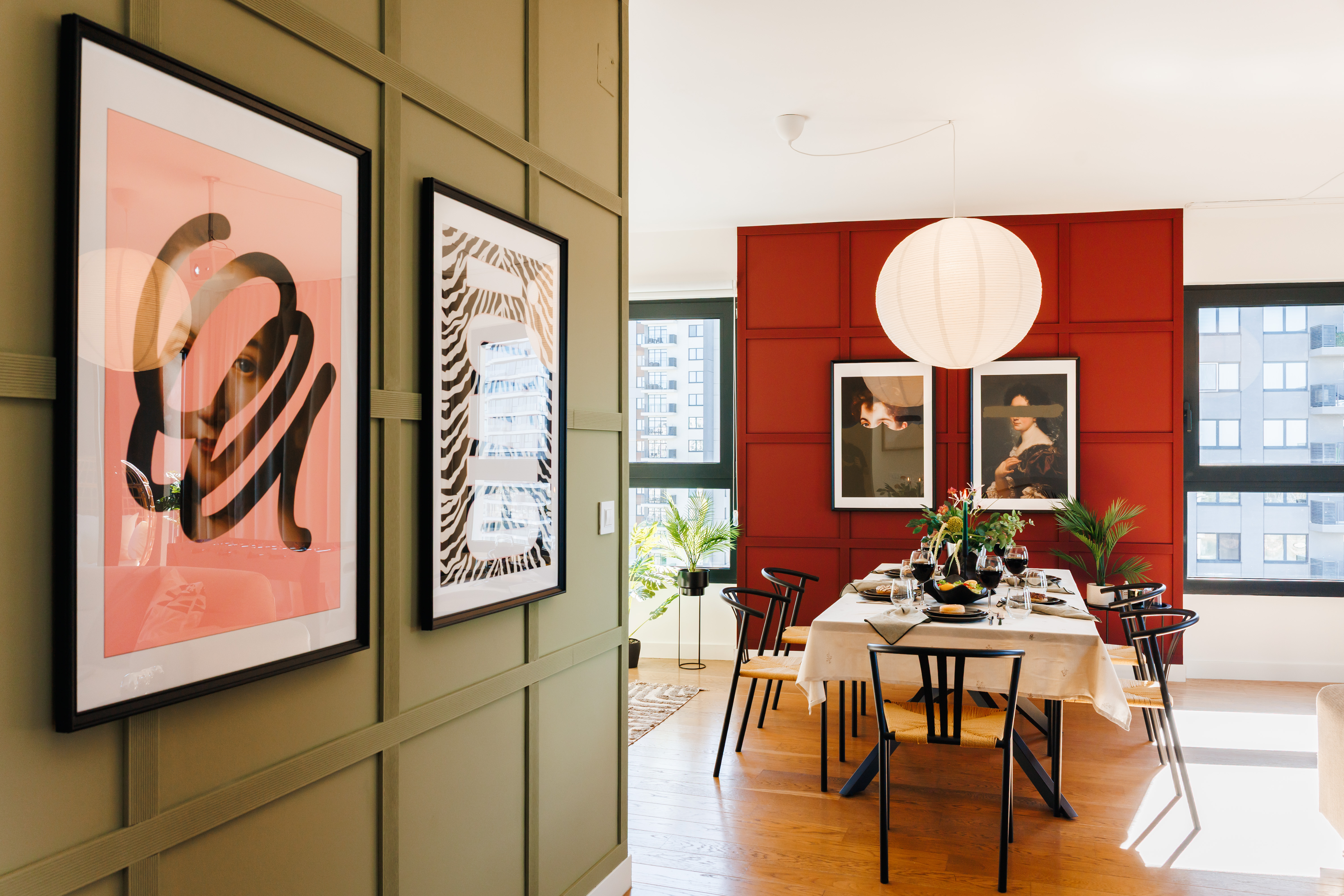 Bright designer dining room with bold art, city views, and natural light