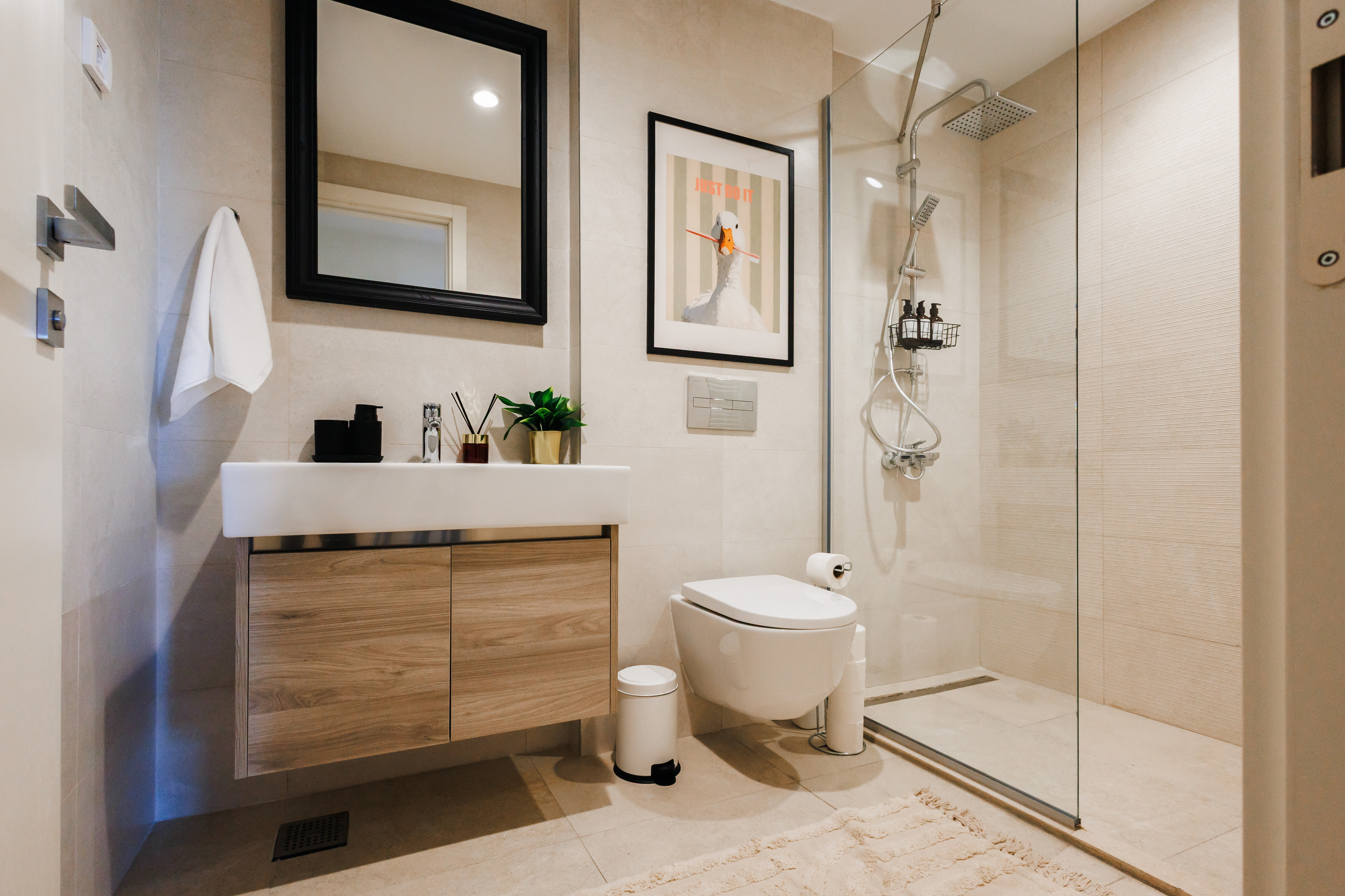 Modern spa-style bathroom with glass walk-in rain shower