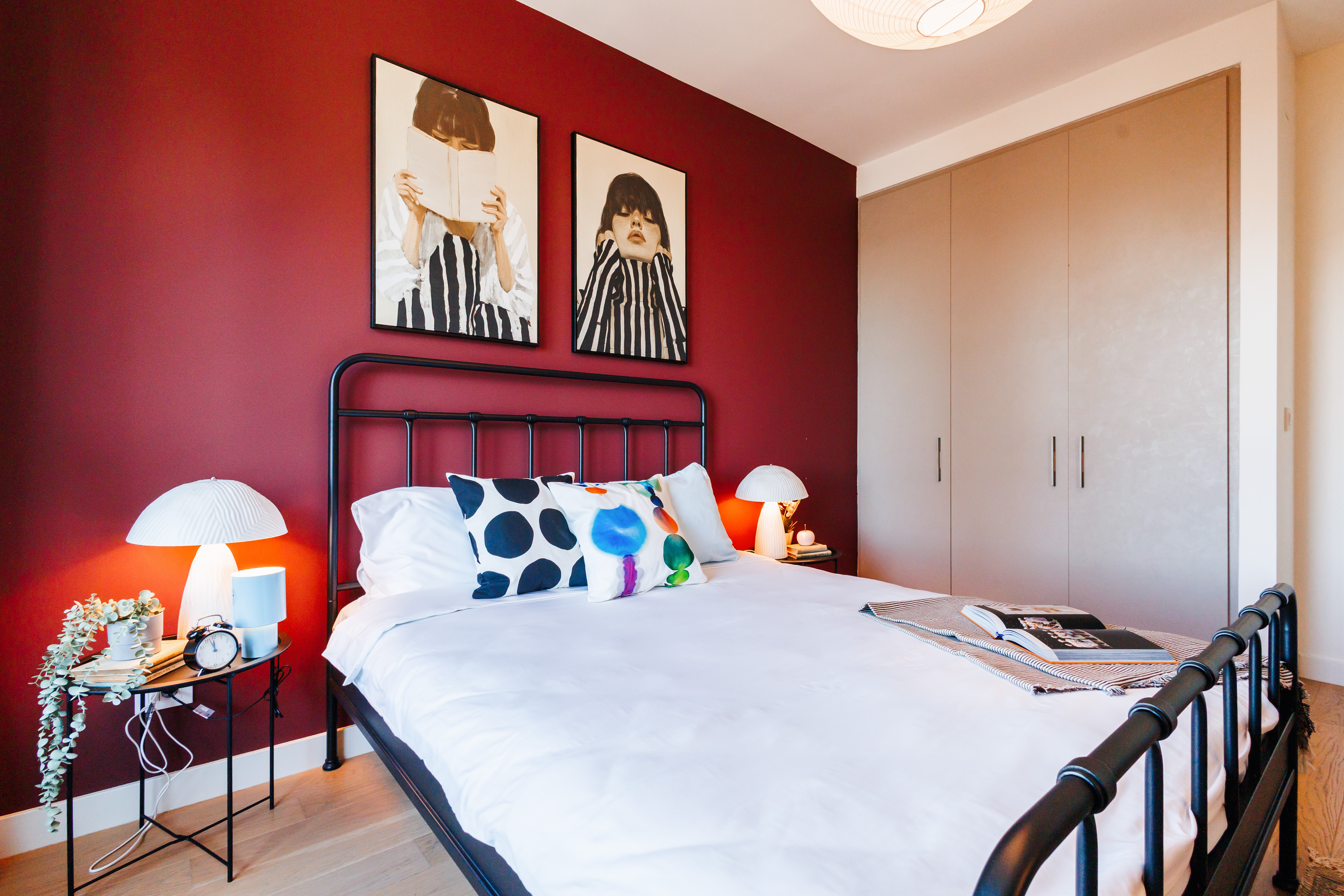 Stylish bedroom with bold accent wall, cozy lighting, and ample storage