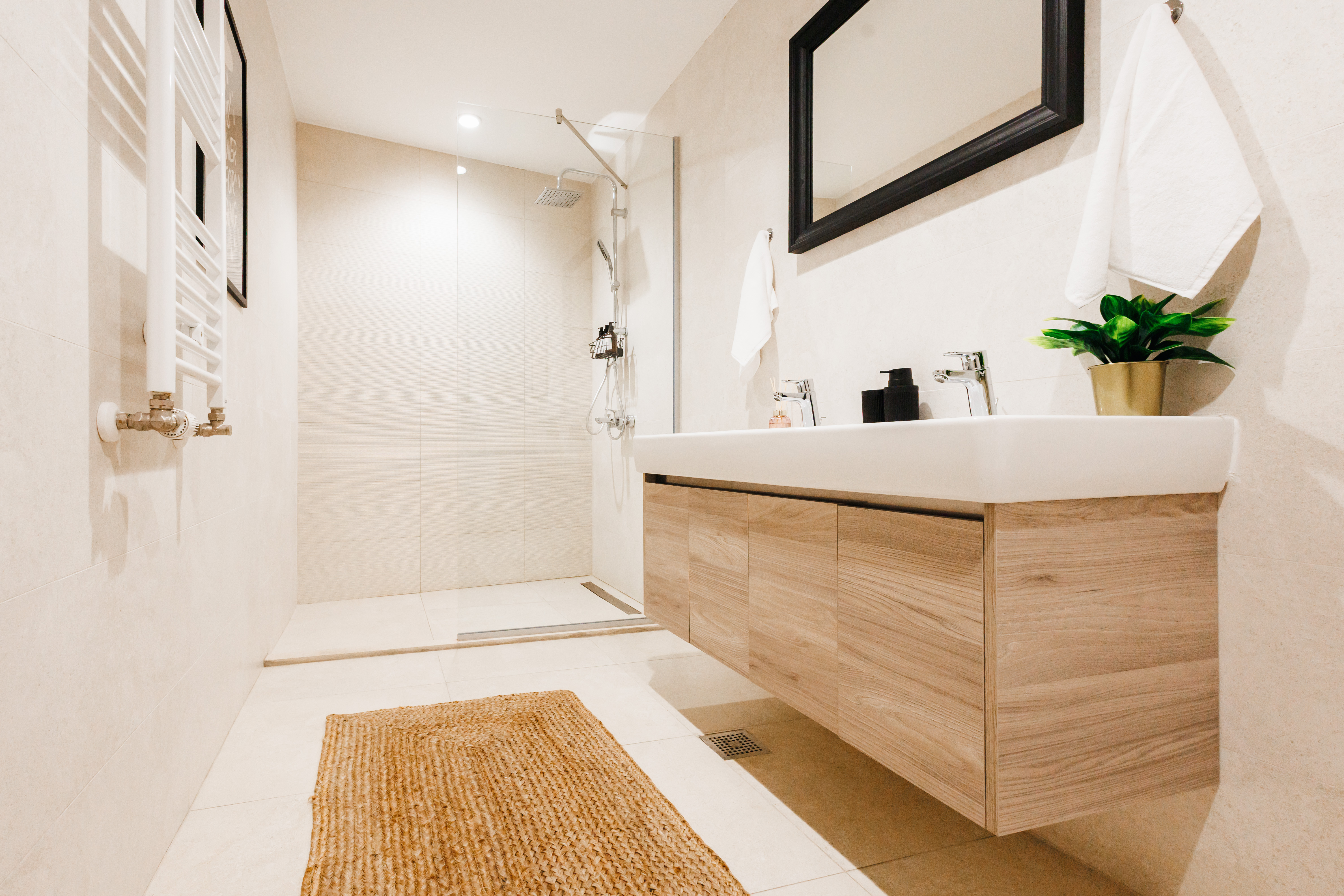 Bright modern bathroom with walk-in rain shower and double vanity