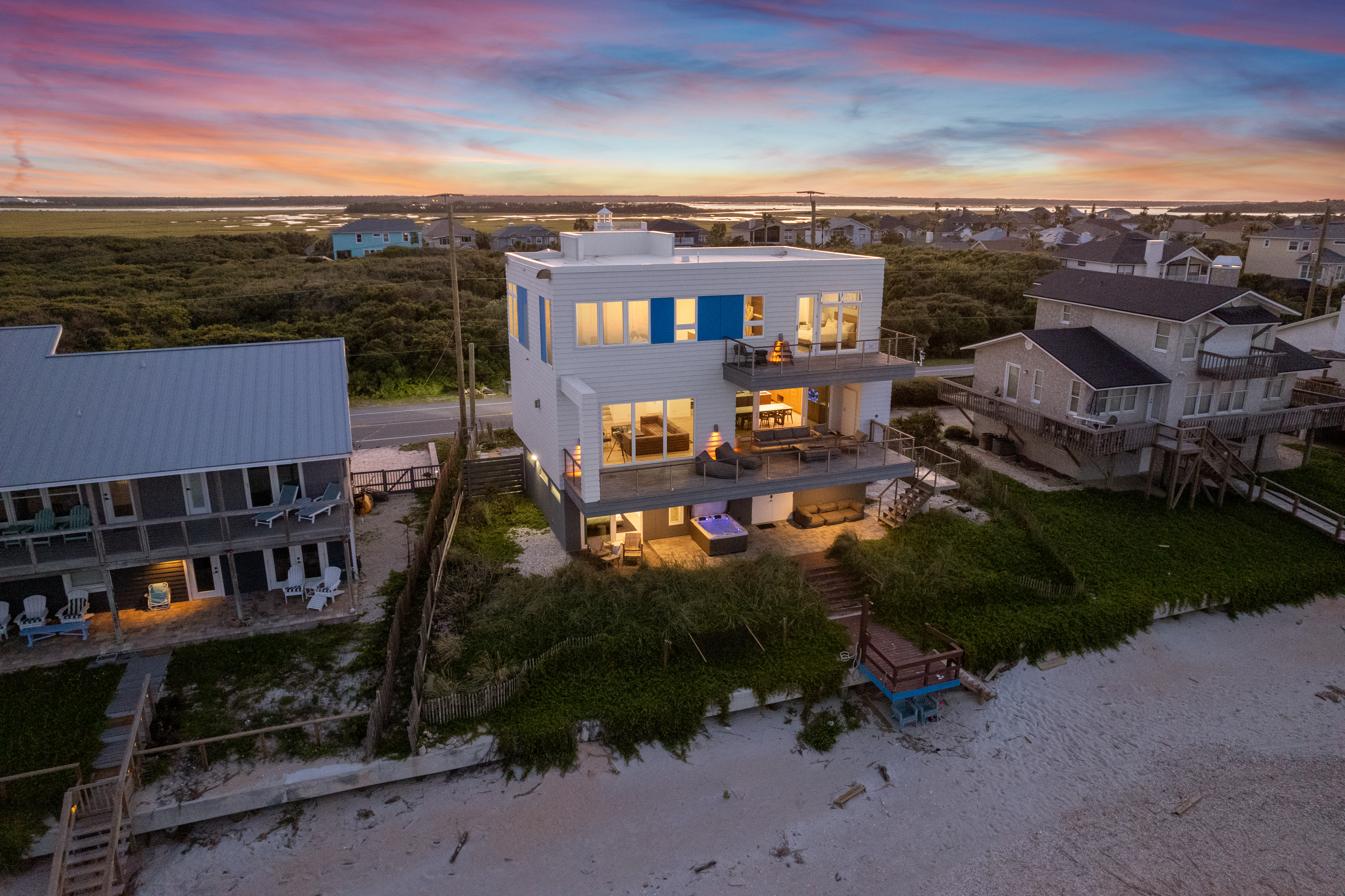 Modern beachfront retreat with sunset views, balconies, and a private hot tub