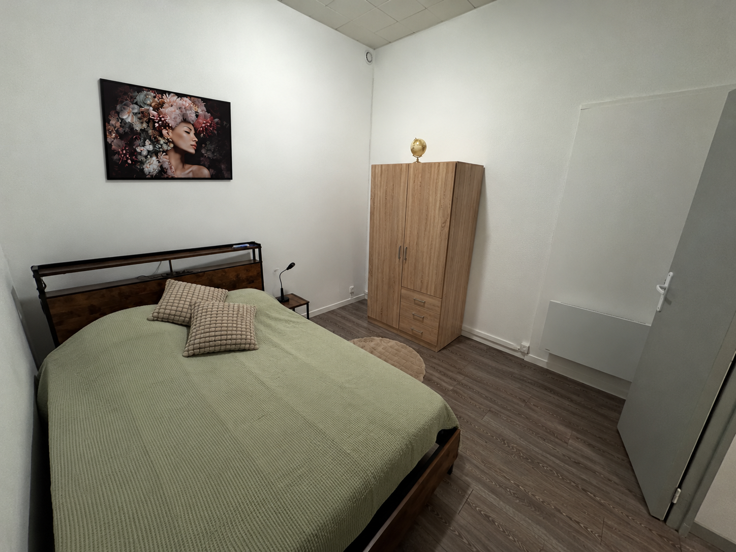 Cozy double bedroom with warm wood accents and practical storage