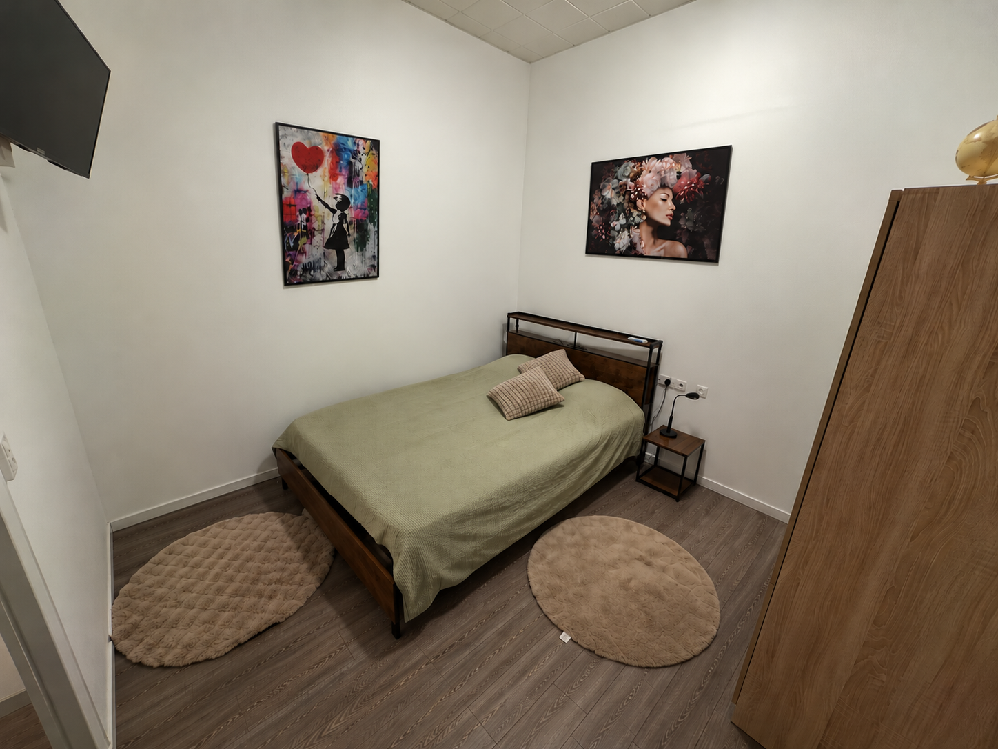 Cozy minimalist bedroom with stylish art and warm wood accents