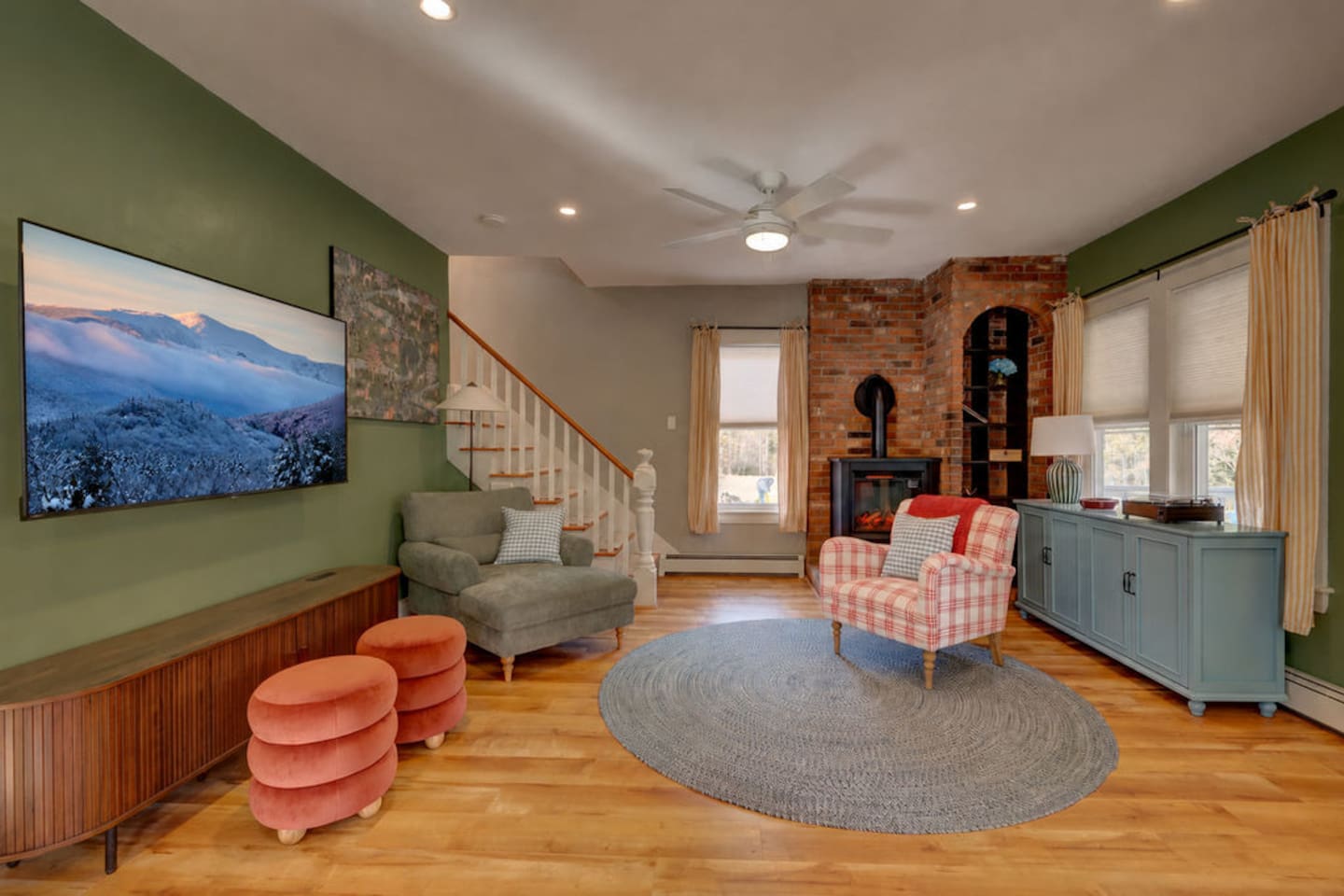 Relax in the living room featuring a cozy fireplace, record player, and Roku TV with Guest Mode. Perfect for movie nights, music, or gathering with family and friends after skiing, hiking, or exploring North Conway and the White Mountains.
