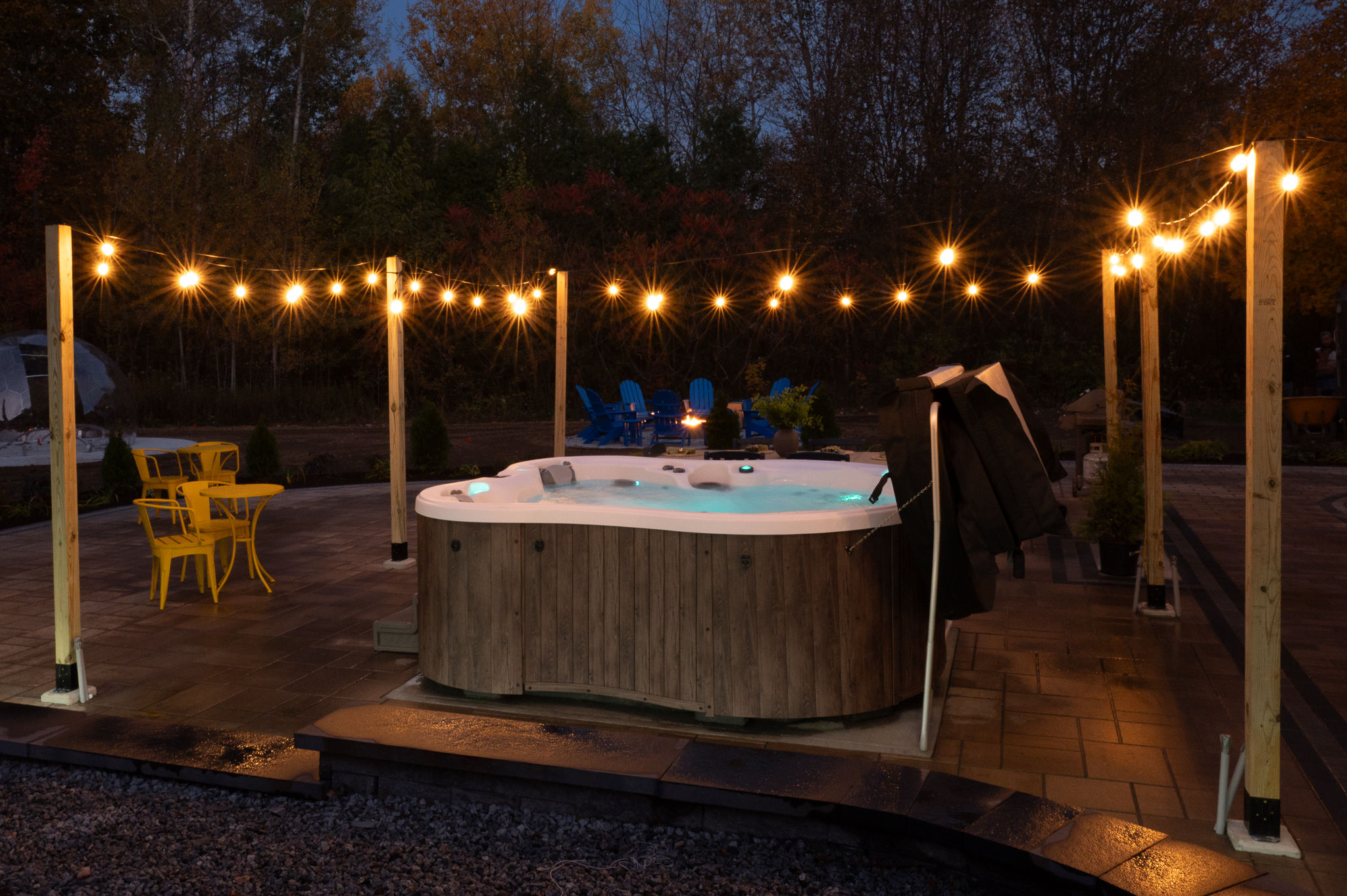 Relax in the hot tub under glowing string lights on the private patio