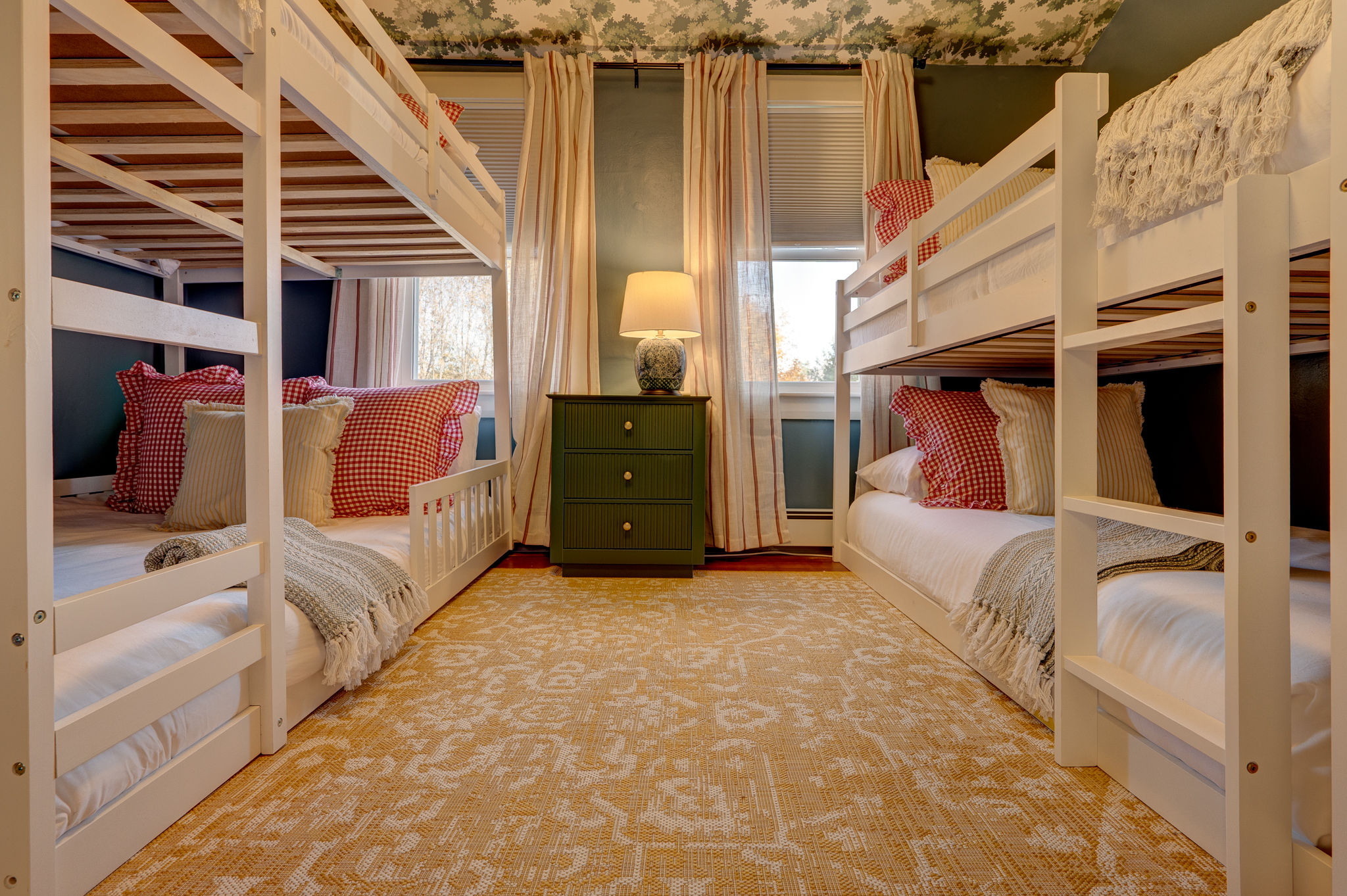 Charming bunk room with 4 built-in beds, warm lighting, and family-friendly style