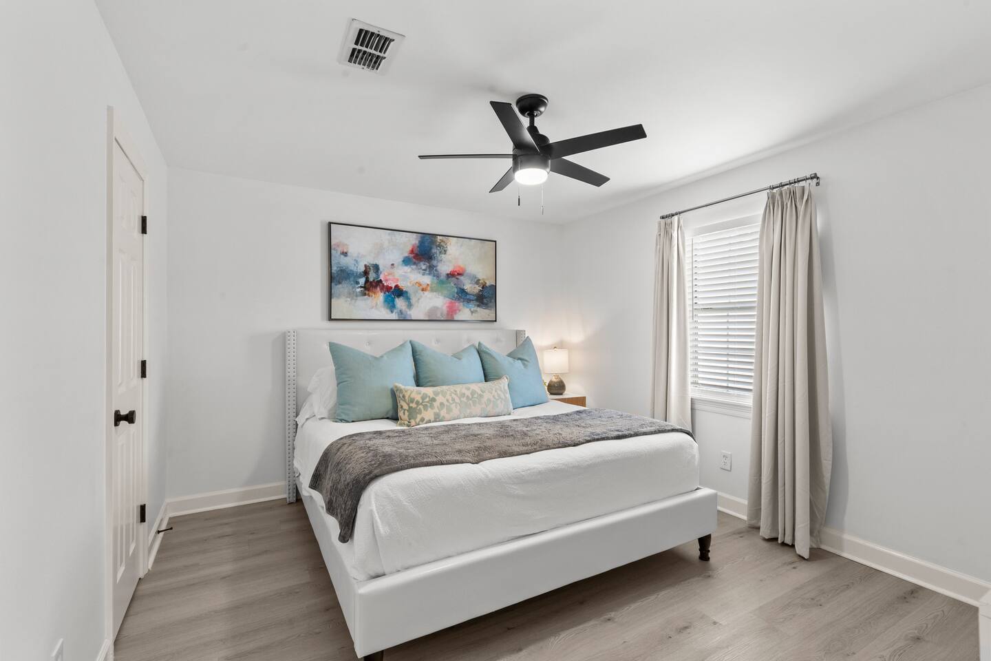 Bbedroom 1 - king ensuite with a full bathroom, walk-in closet, blackout curtains with a TV.