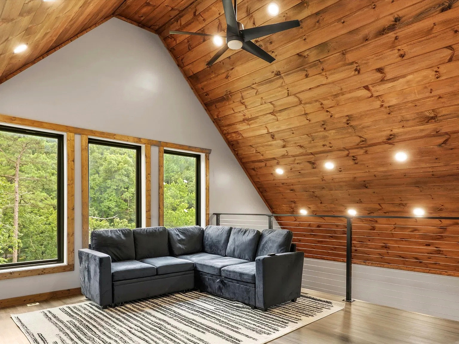 Cozy loft lounge with forest views and stunning vaulted wood ceilings