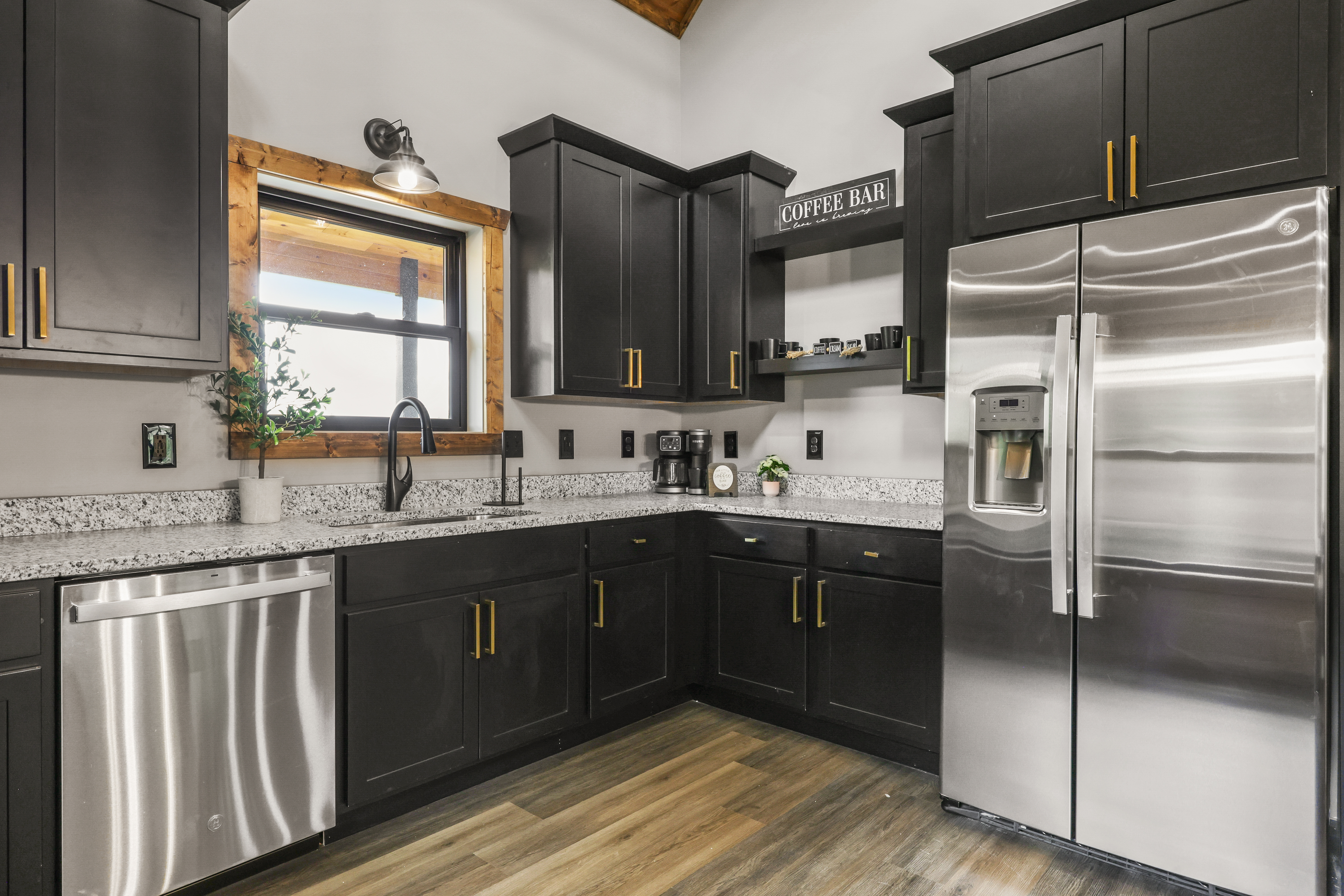 Modern kitchen with stainless appliances and a charming coffee bar