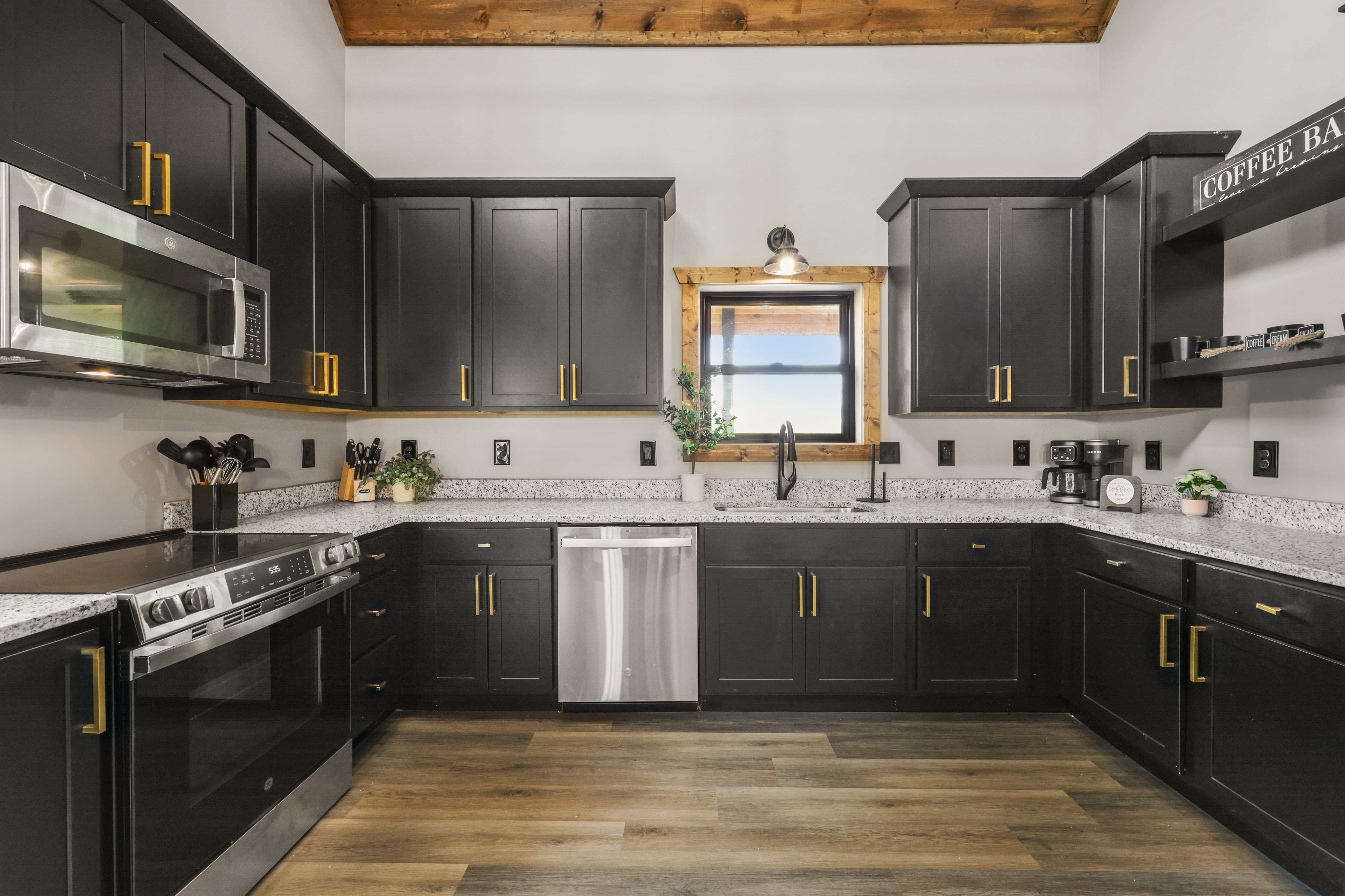 Modern farmhouse kitchen with stainless appliances and stylish coffee bar
