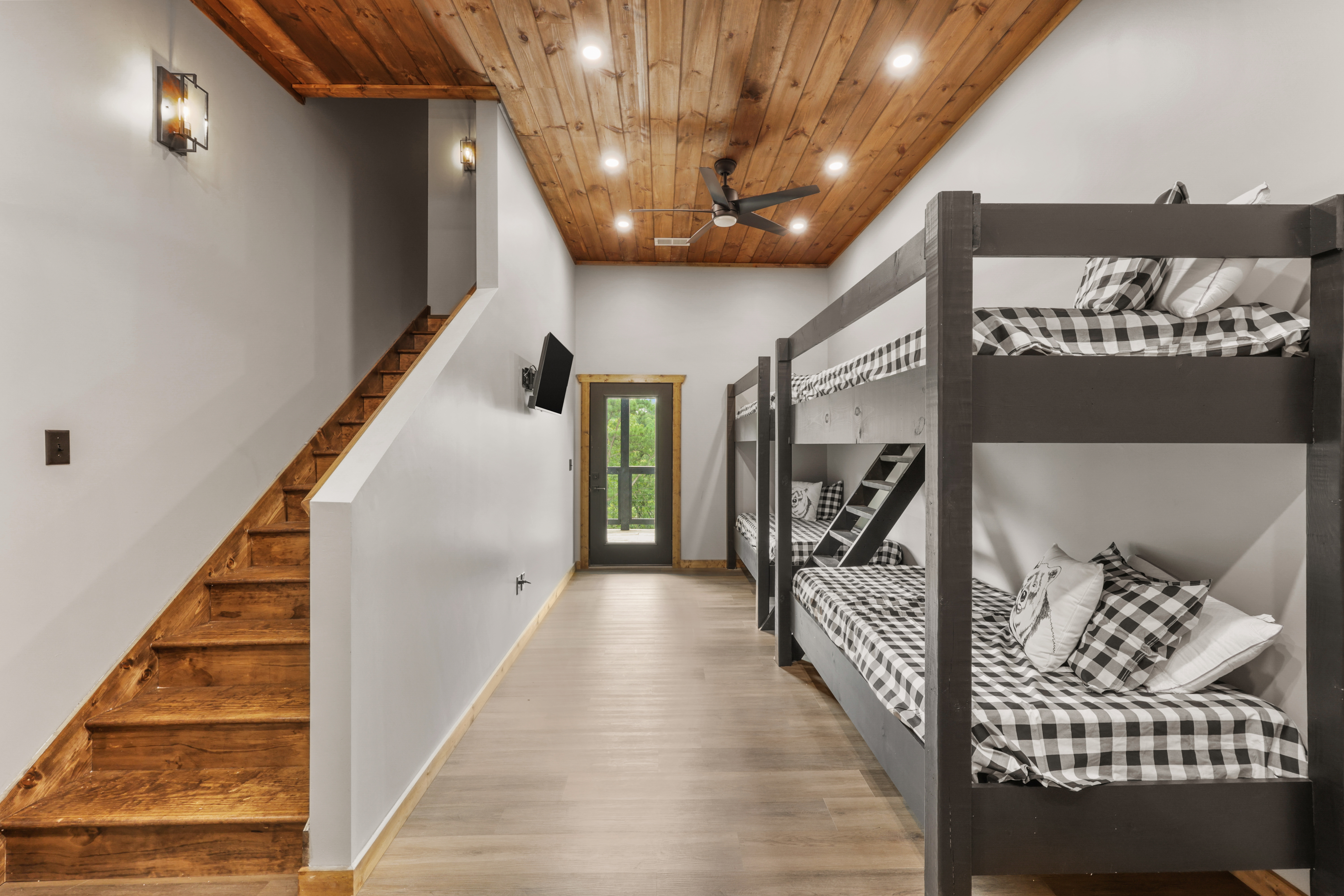 Spacious modern bunk room with rustic wood accents and group-friendly sleeping