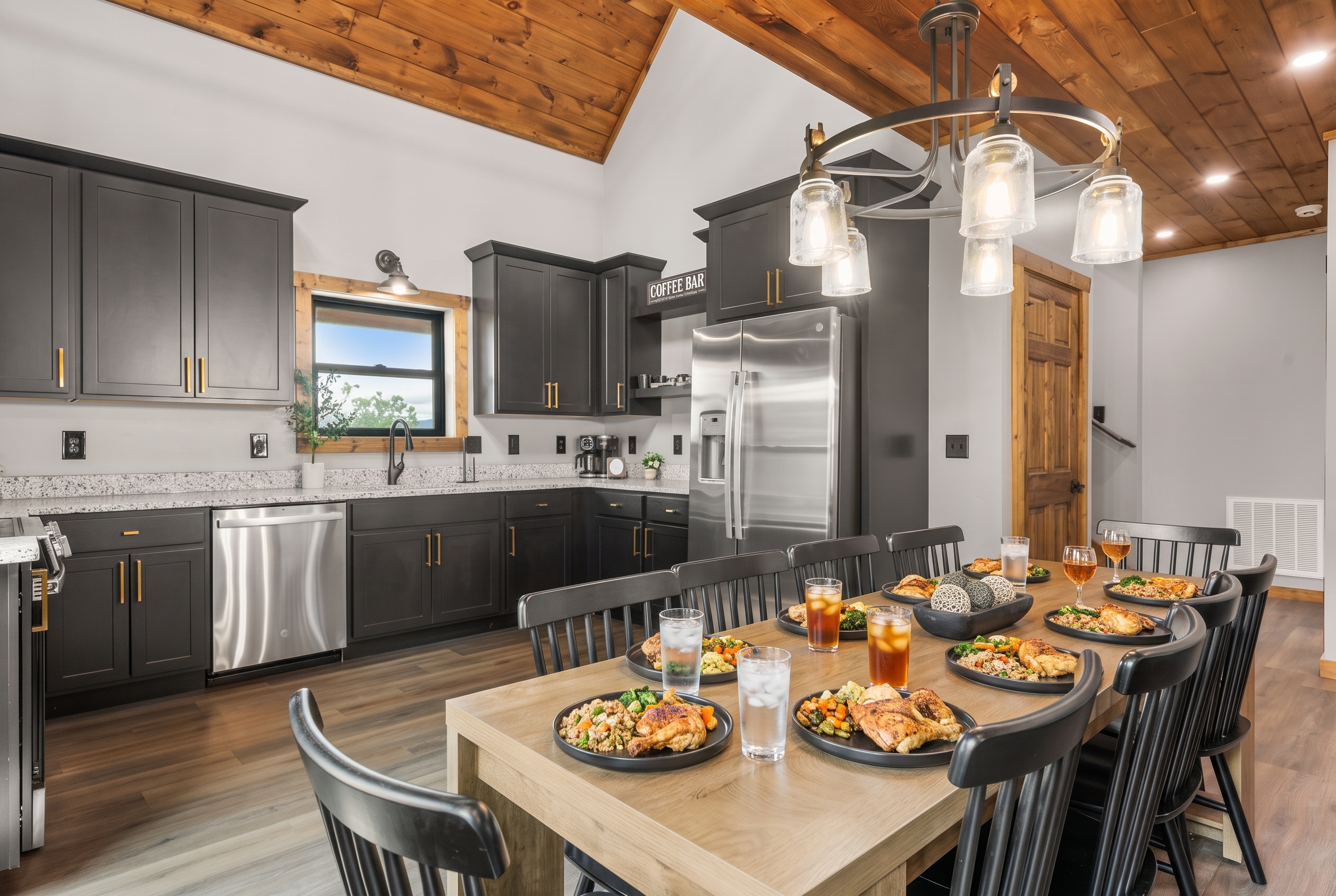 Modern-rustic kitchen with vaulted wood ceilings and dining for a group