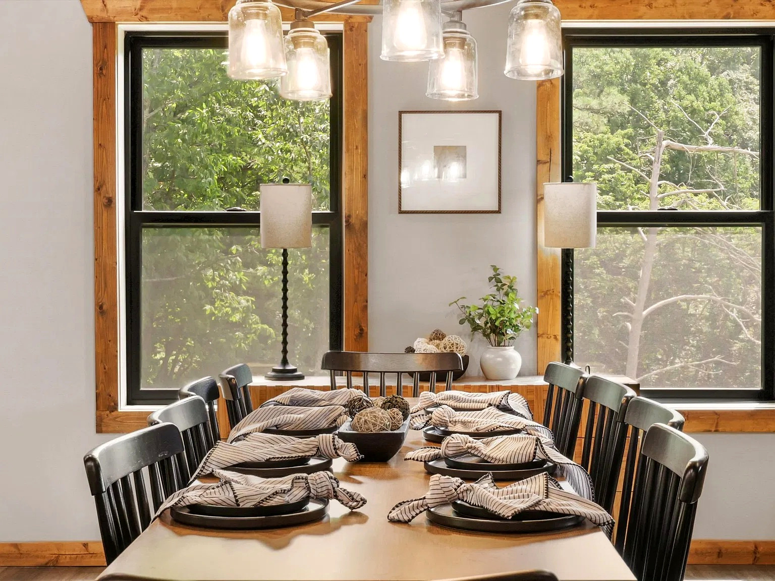 Bright rustic dining room with forest views and seating for a group