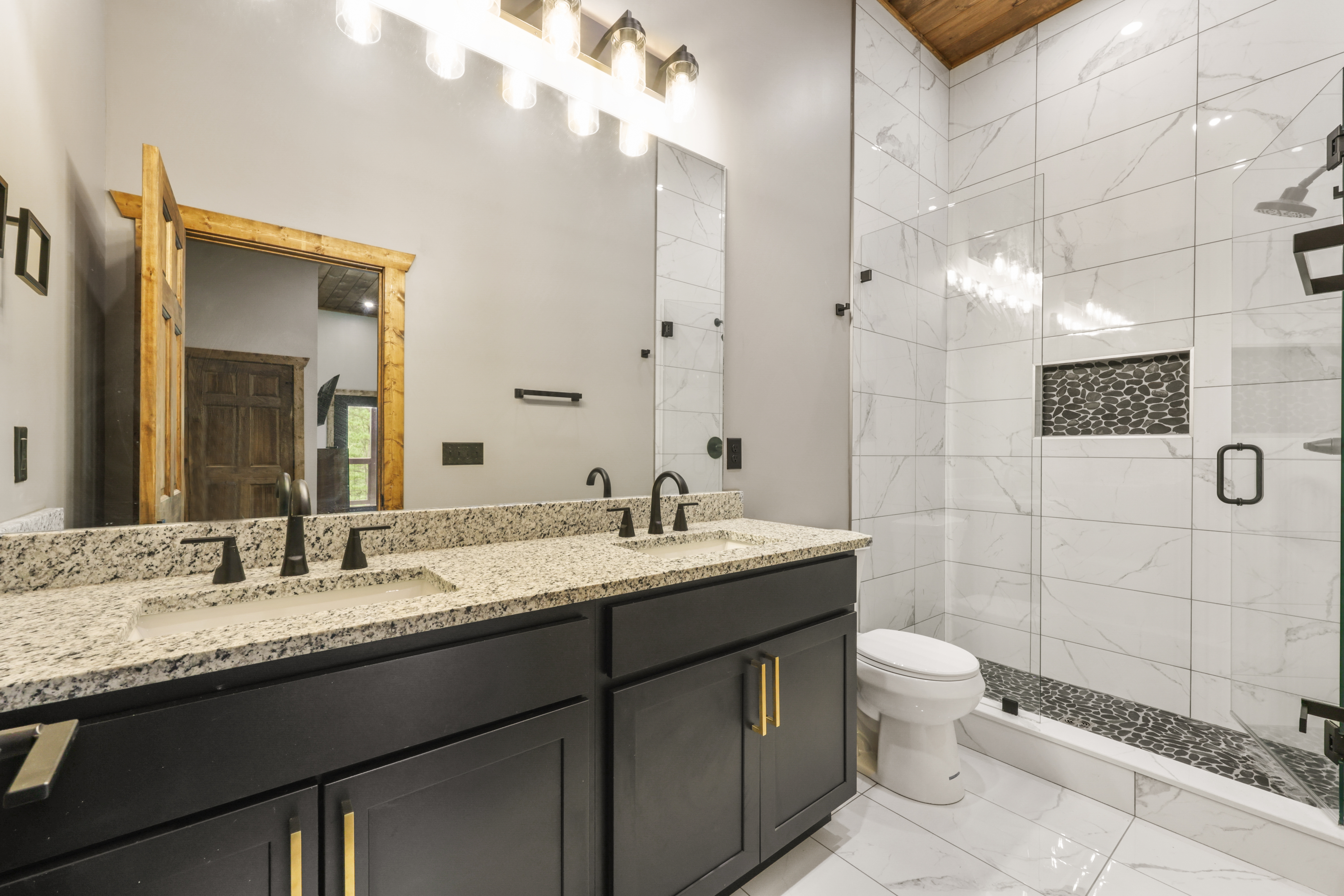 Spa-like bathroom with double vanity and sleek glass walk-in shower