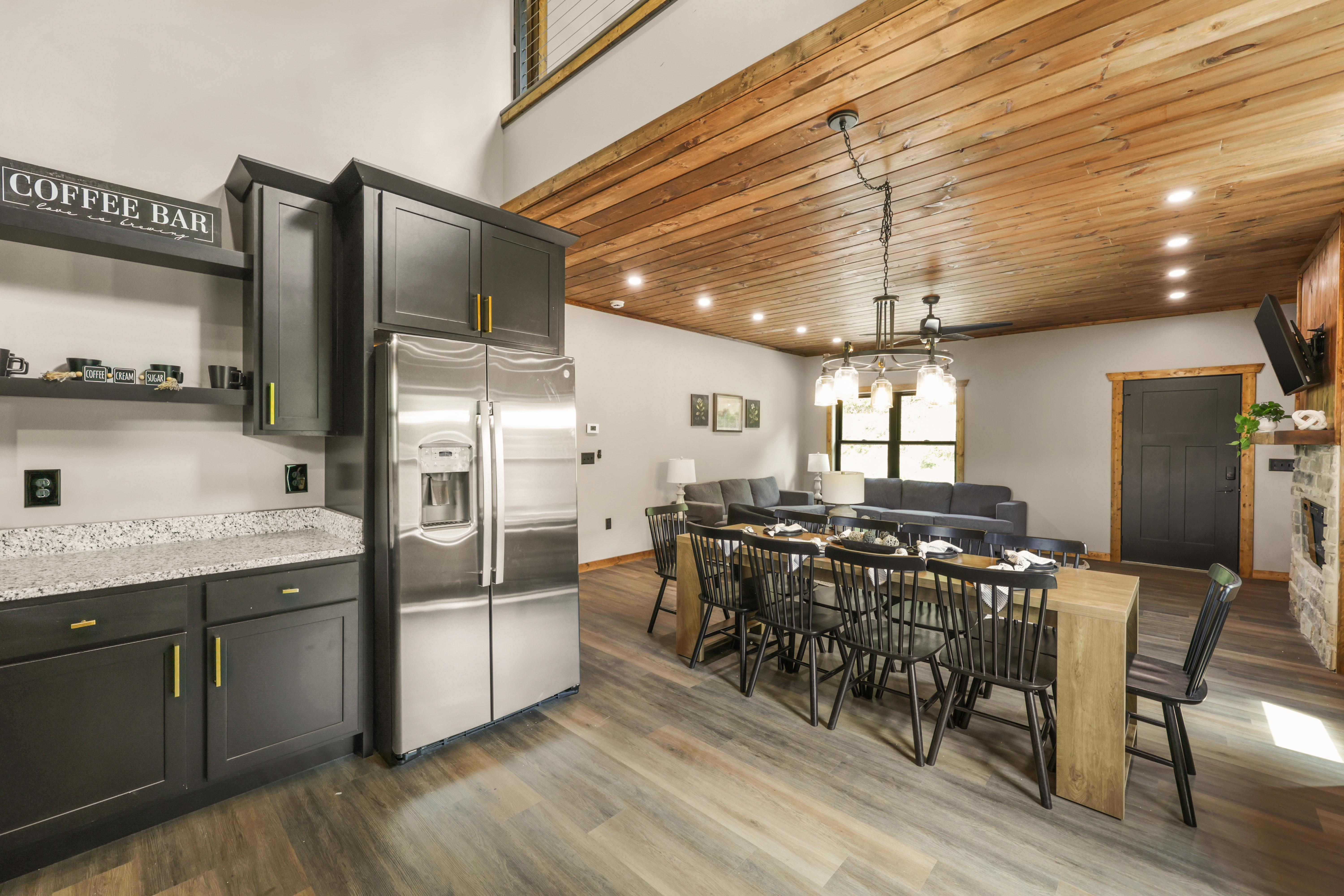 Spacious rustic-modern great room with coffee bar, fireplace, and dining for 8