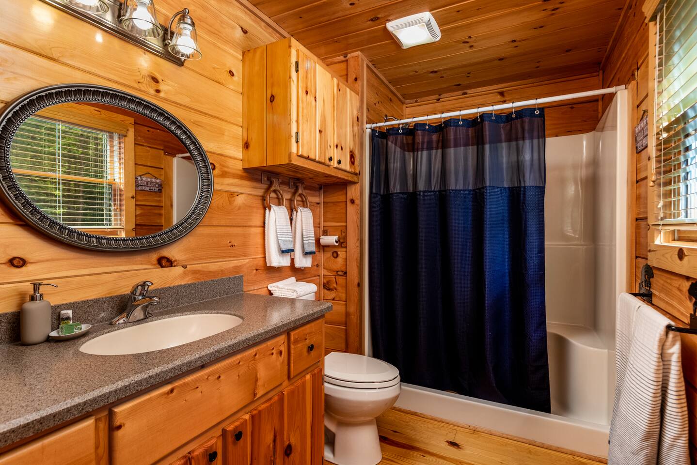 Master bath with a hair dryer and first aid kit in the cabinet.