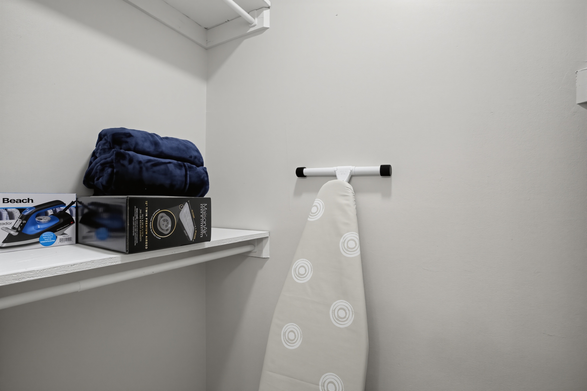Handy utility closet with ironing board and extra guest essentials